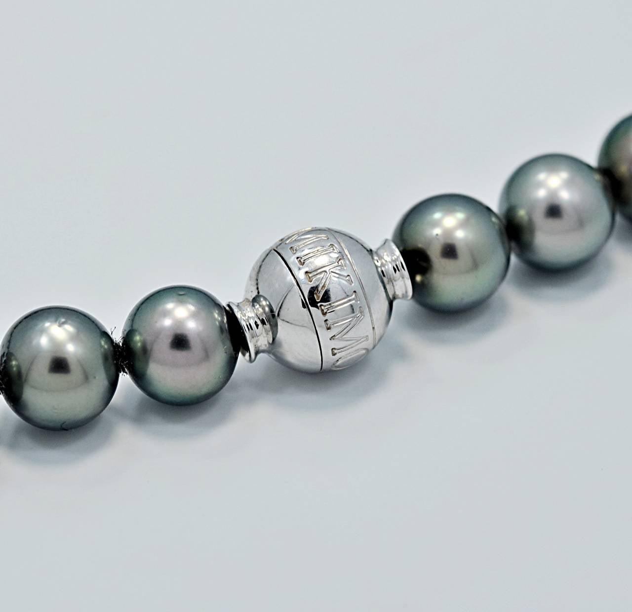 J34076

This is an exquisite and luscious South Sea Black/Peacock Green Mikimoto Strand of Pearls. The clasp is 18k white gold and has a small diamond. The pearls measure 8.2mm - 10.5mm and are perfectly round and color matched. The strand