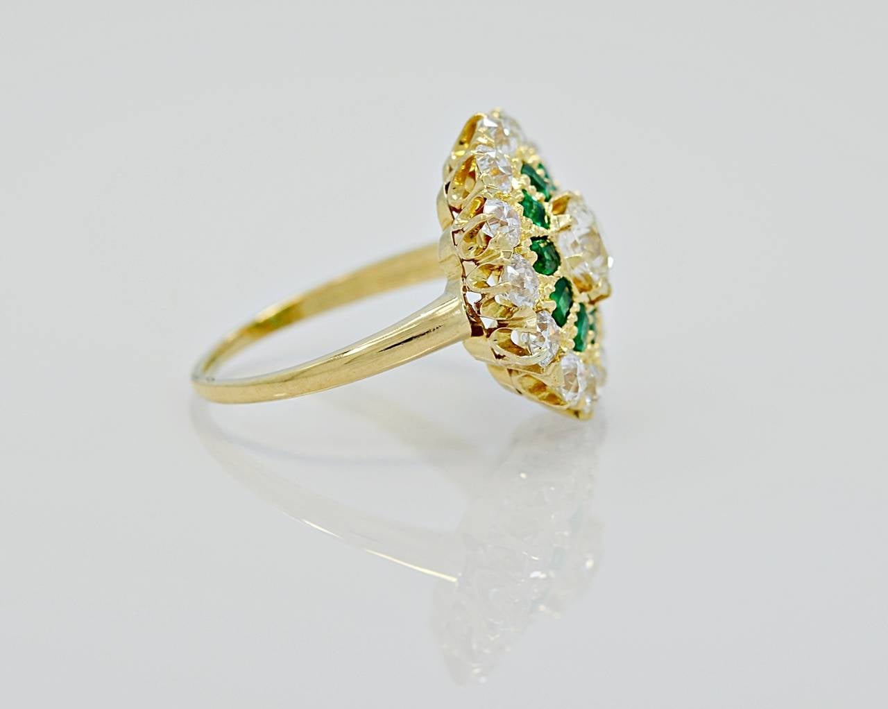 J35080

This antique Edwardian fashion ring is of extreme rarity featuring a .60ct. apx. center round European cut diamond with 1.30ct. apx. melee and .70ct. apx. of Columbian emeralds. The center diamond is SI2 in clarity and G-H color. The