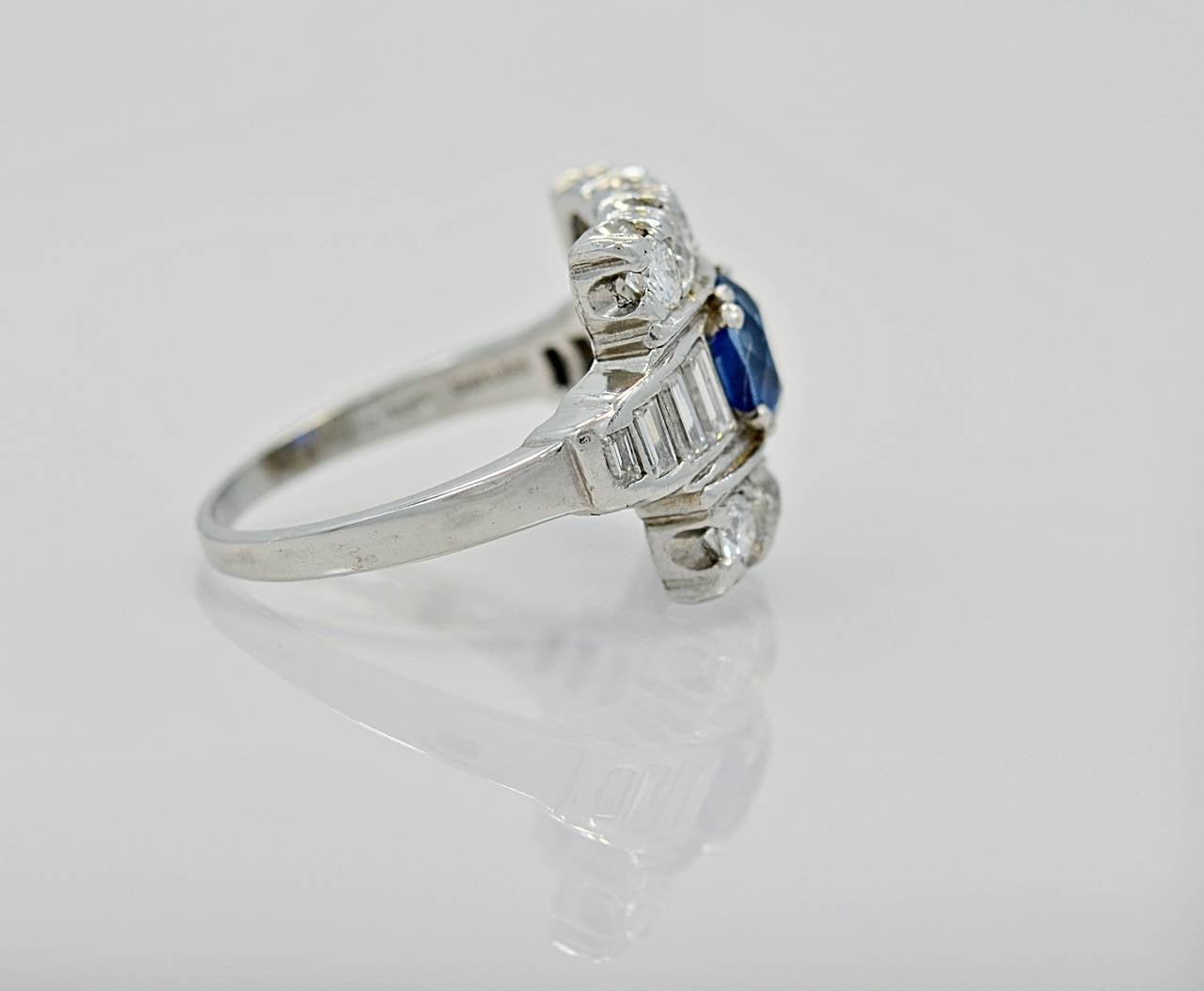 J34861

A strikingly beautiful Platinum, 1.38ct. Apx. Sapphire and 1.33ct. Apx. T.W. Diamond Melee Art Deco ring. The natural Sapphire is of very fine quality and incredible color. This stunning ring can be worn as a stand-alone right hand ring or