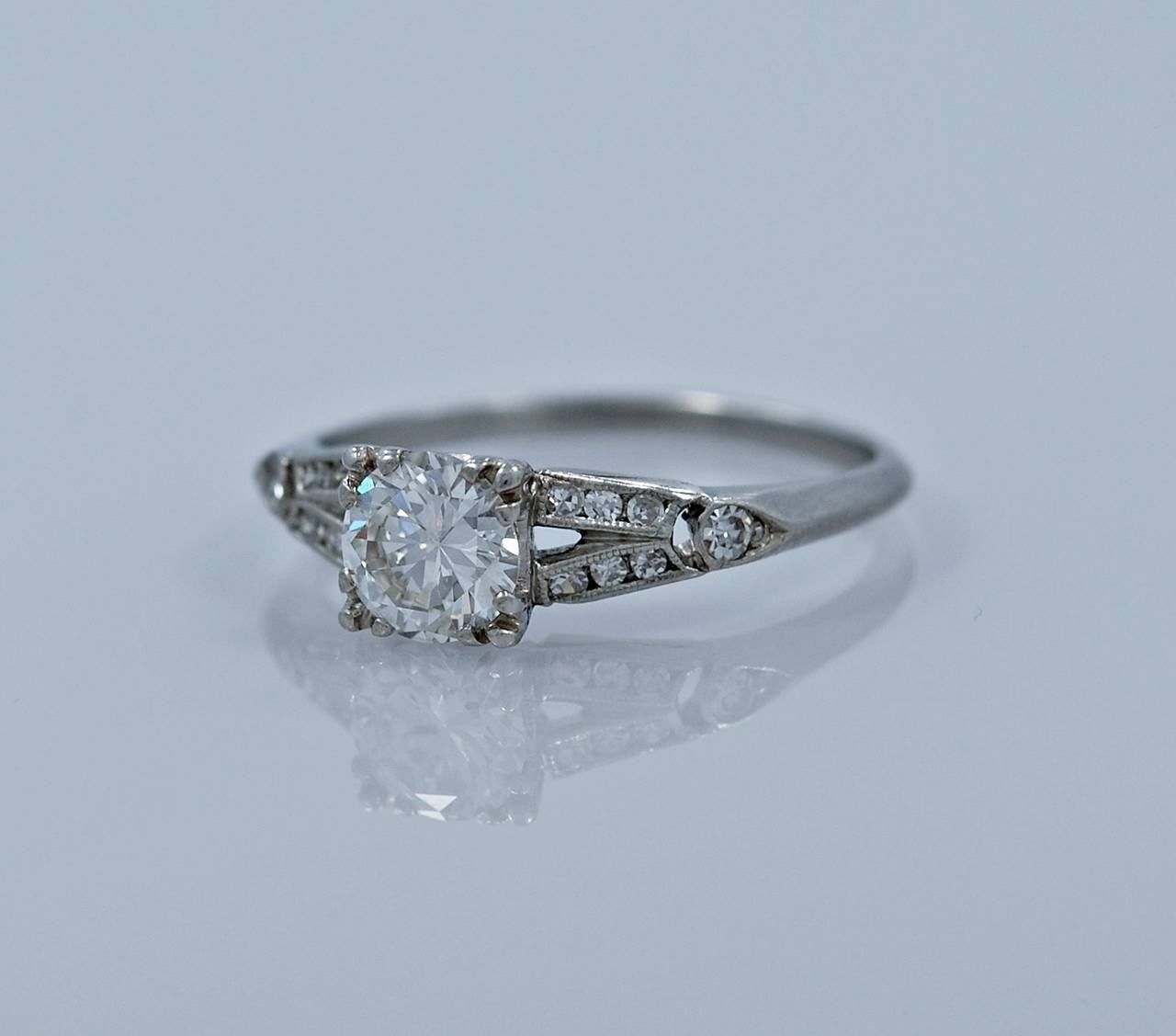 J34575

REASONABLE OFFERS CONSIDERED!

A gorgeous platinum Art Deco engagement ring featuring a .60ct. apx. round transitional diamond with accompanying .10ct. apx. T.W. of diamond melee in carved 