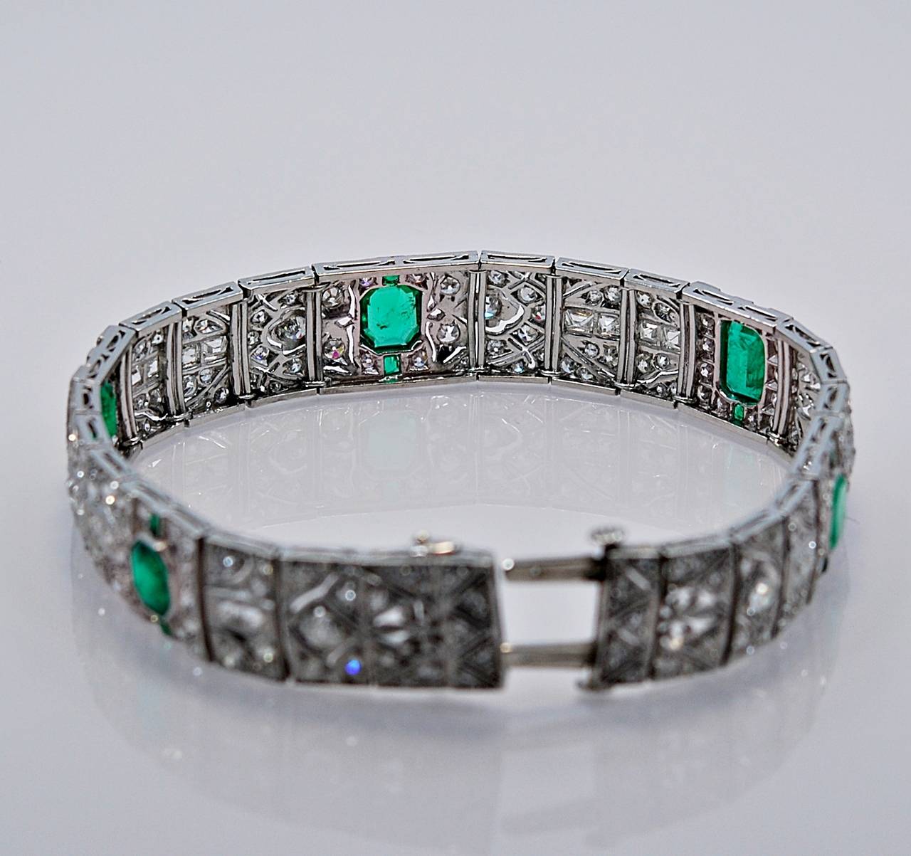 J35142

REASONABLE OFFERS CONSIDERED!

Extremely fine Art Deco platinum, diamond, and emerald bracelet. Beautifully constructed in platinum and contains approximately 6 carats of fine diamonds and approximately 5 carats of fine Columbian