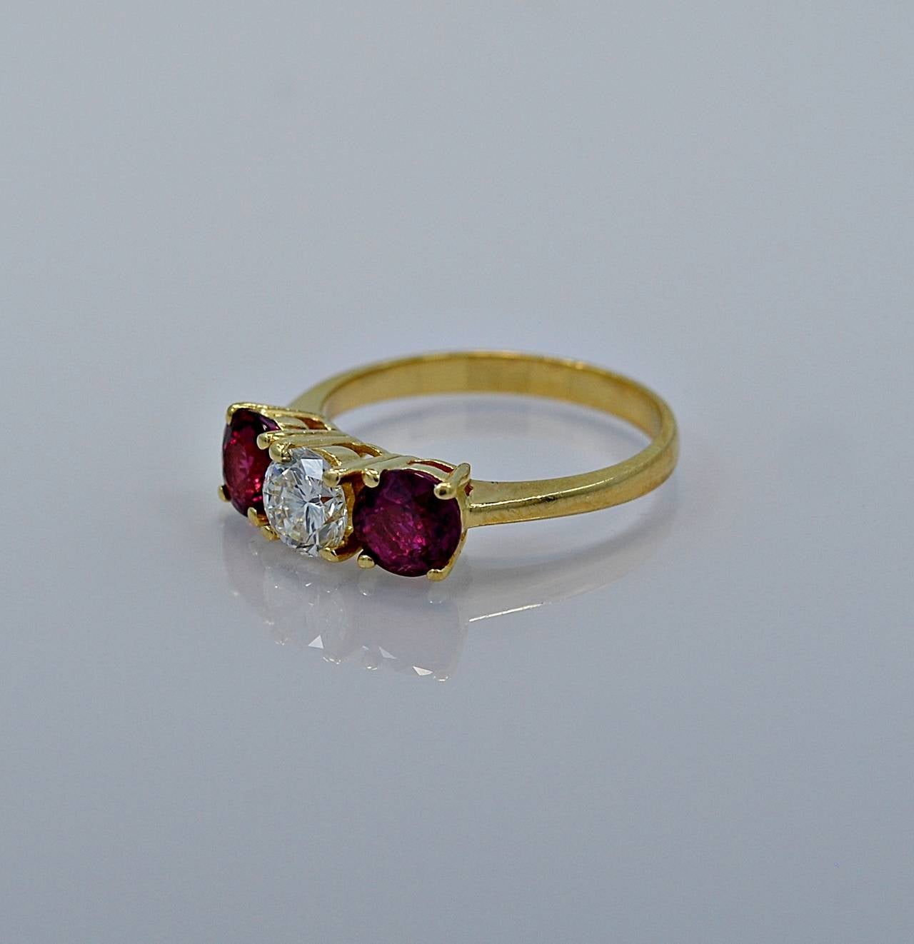 J35081

REASONABLE OFFERS CONSIDERED!

Timeless and classic! This Estate 1950's engagement ring features 1.30ct. apx. T.W. of natural rubies with a .65ct. apx. round brilliant center stone. The color is F and the clarity is VS1. This is an