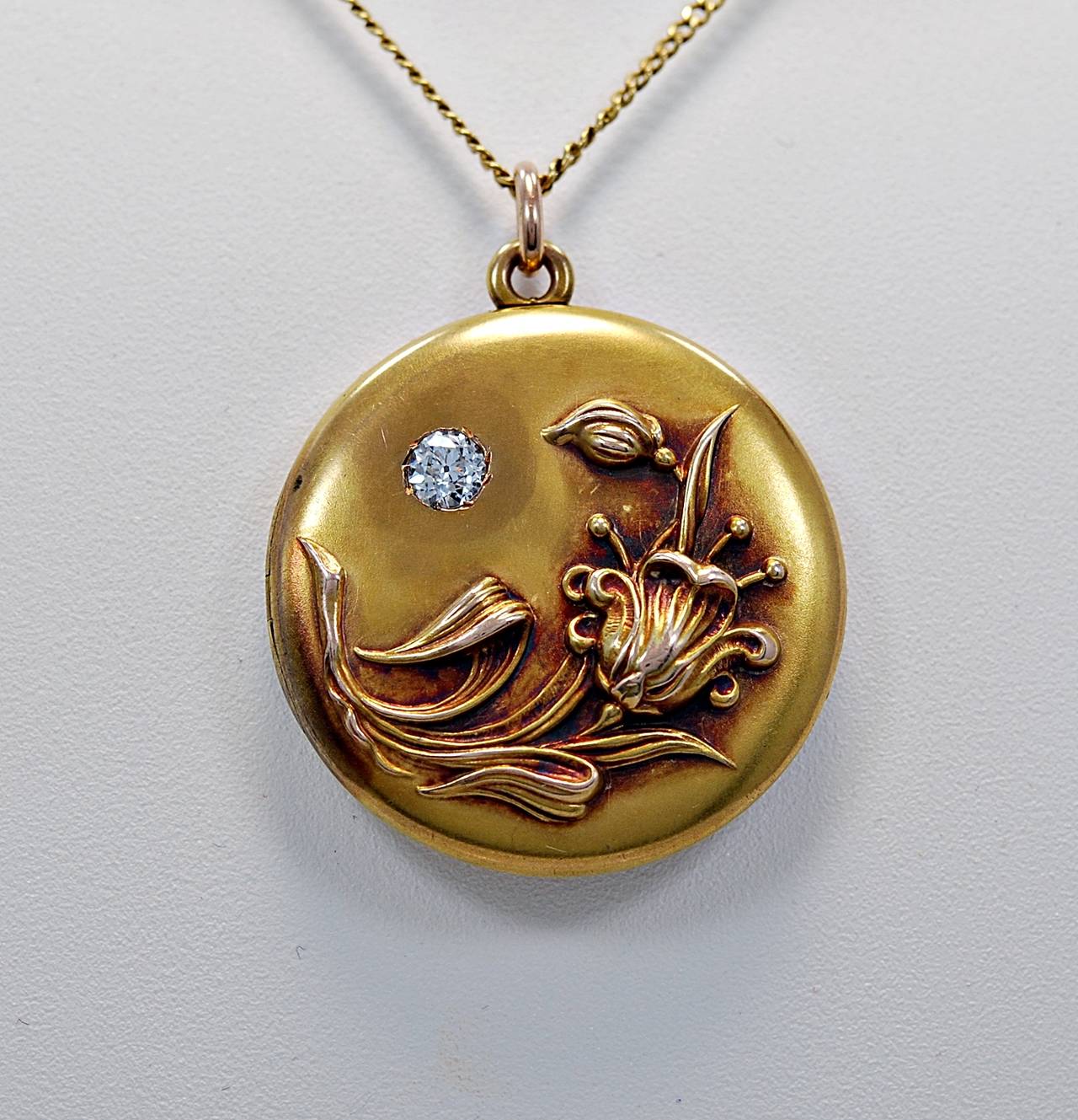 J35139

REASONABLE OFFERS CONSIDERED!

A very impressive Art Nouveau 14K yellow gold and diamond locket featuring a VVS2 clarity, D-E-F (colorless) and .35ct. apx. European cut diamond. This locket is decorated with a flowing flower with petals,