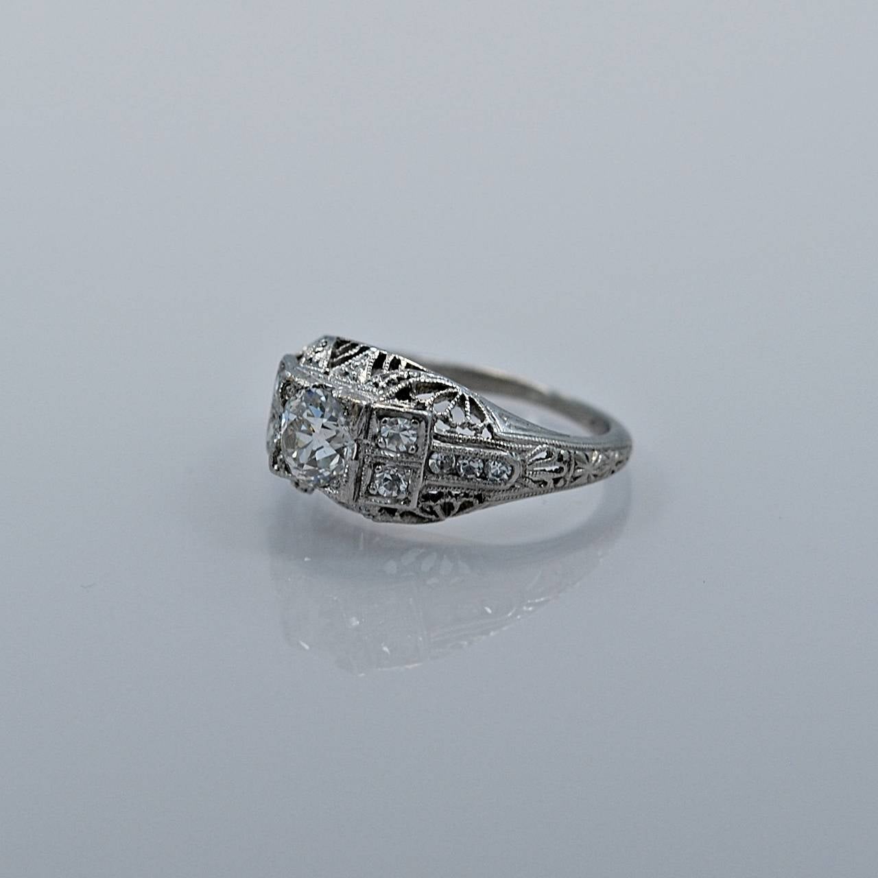 An exceptional Platinum & Diamond Art Deco Engagement Ring by S. Kirk & Son. This beautiful ring is highlighted by gorgeous filigree & pierced decoration, supporting a .53ct. apx. European cut diamond that is VS2 in clarity and H in color. The