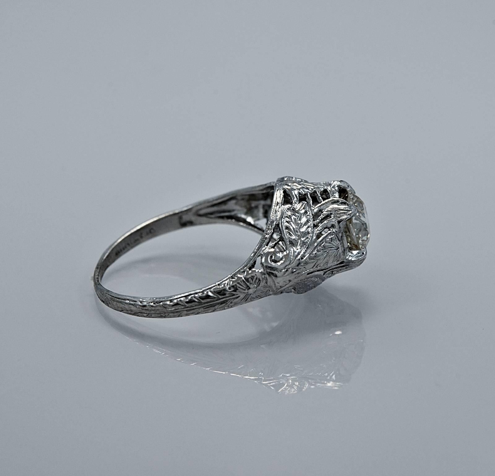 An Art Deco platinum & diamond engagement ring featuring a .68ct. apx. European cut diamond of SI1 clarity and J color. What a fabulous ring! It is finely pierced and possesses scroll work and detailed engraving of flowers and leaves. This ring is a