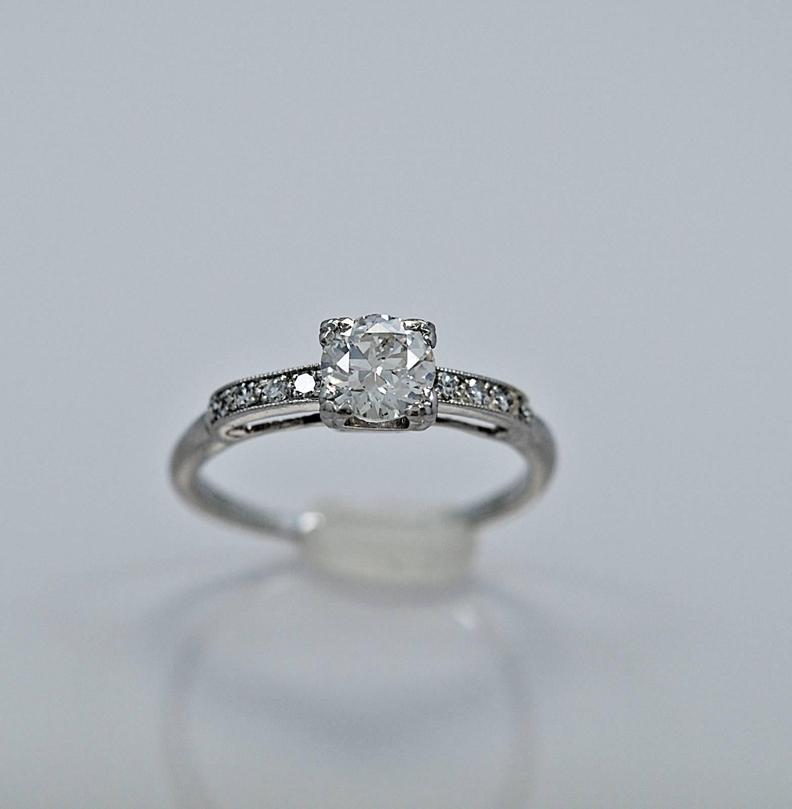 Lovely Art Deco platinum & diamond engagement ring featuring a .54ct. apx. diamond of SI2 clarity and H color. The diamond melee weighing .08ct. apx. T.W. adds a touch of elegance to this classic style engagement ring. Very dainty and feminine!