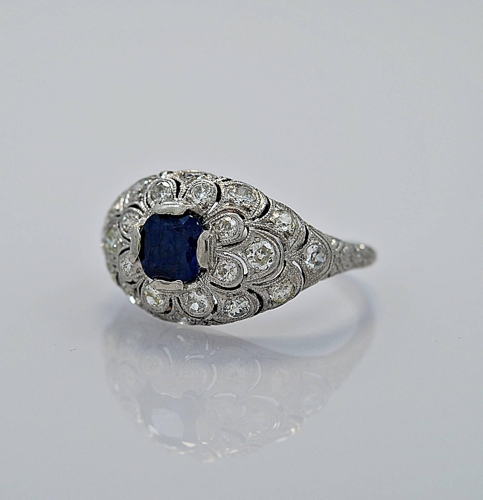 In our Tampa store, this item has a retail price of $6,995.

An exquisitely detailed platinum sapphire and diamond vintage engagement ring featuring a .85ct. apx. sapphire with no indications of heat treatment. It also has .63ct. apx. of diamond