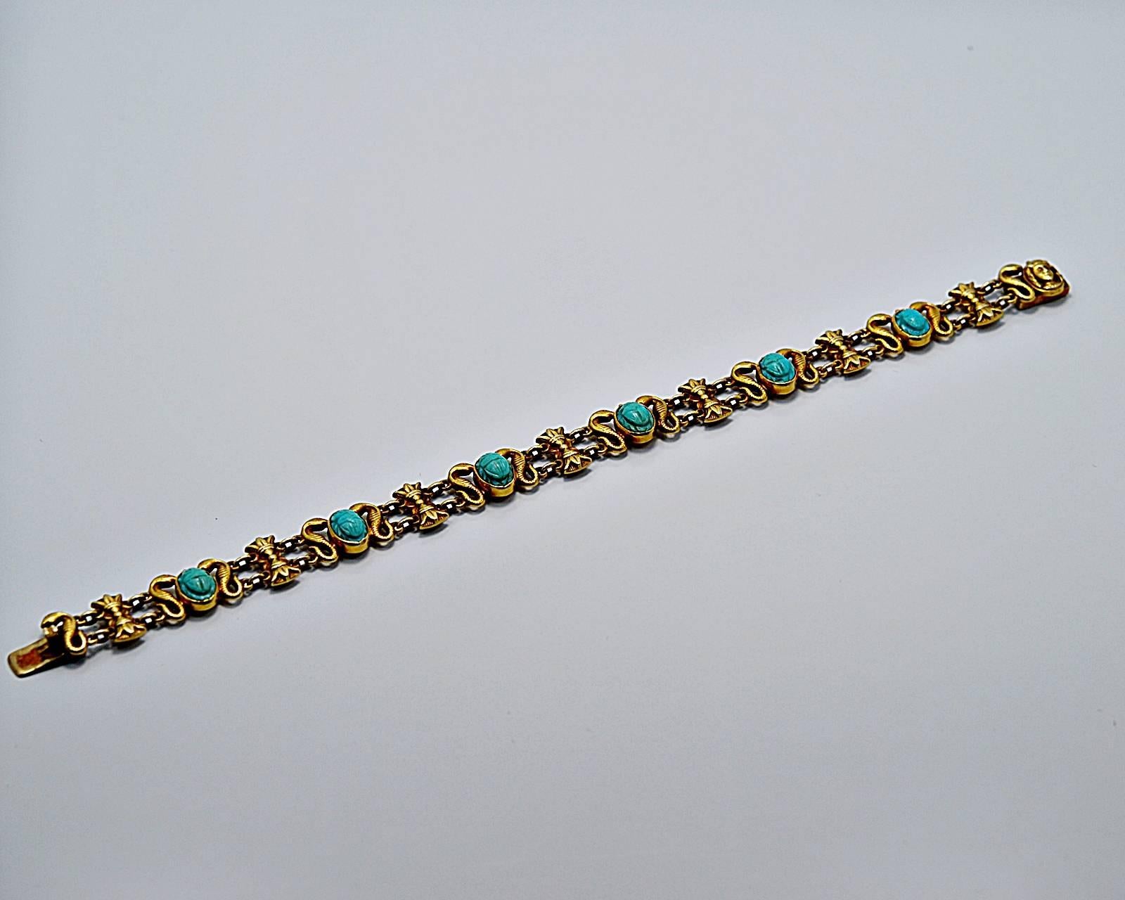 In our Tampa store this item retails for $4,495.

An Art Deco Egyptian revival Persion turquoise bracelet that features six 7.5mm x 5.5mm turquoise scarabs with alternating serpents and sheaves of wheat. At the clasp is a head of a Pharoah.