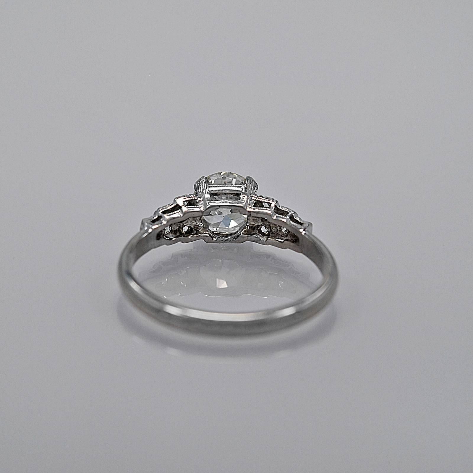 In our Tampa store this has a retail price of $9,995.

An original platinum Art Deco diamond engagement ring featuring a .96ct. apx. European cut center diamond with SI1 clarity and I color. There are diamond melee set on each side of the center