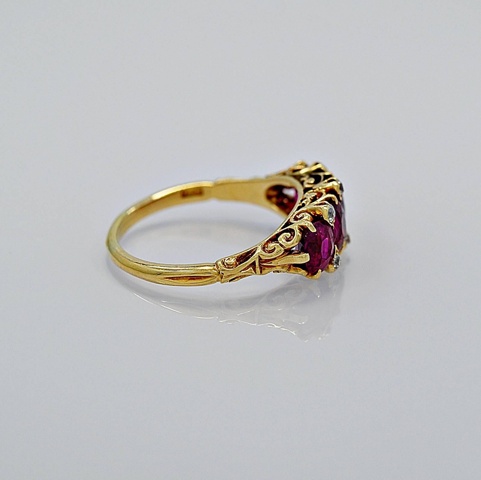 An exceptional quality antique engagement ring with 3.00ct. T.W. of Burma no heat rubies as described in the A.G.L. cert. The rubies are a stunning pinkish red color and are set in an intricately filigreed mounting crafted in rich 18K yellow gold.