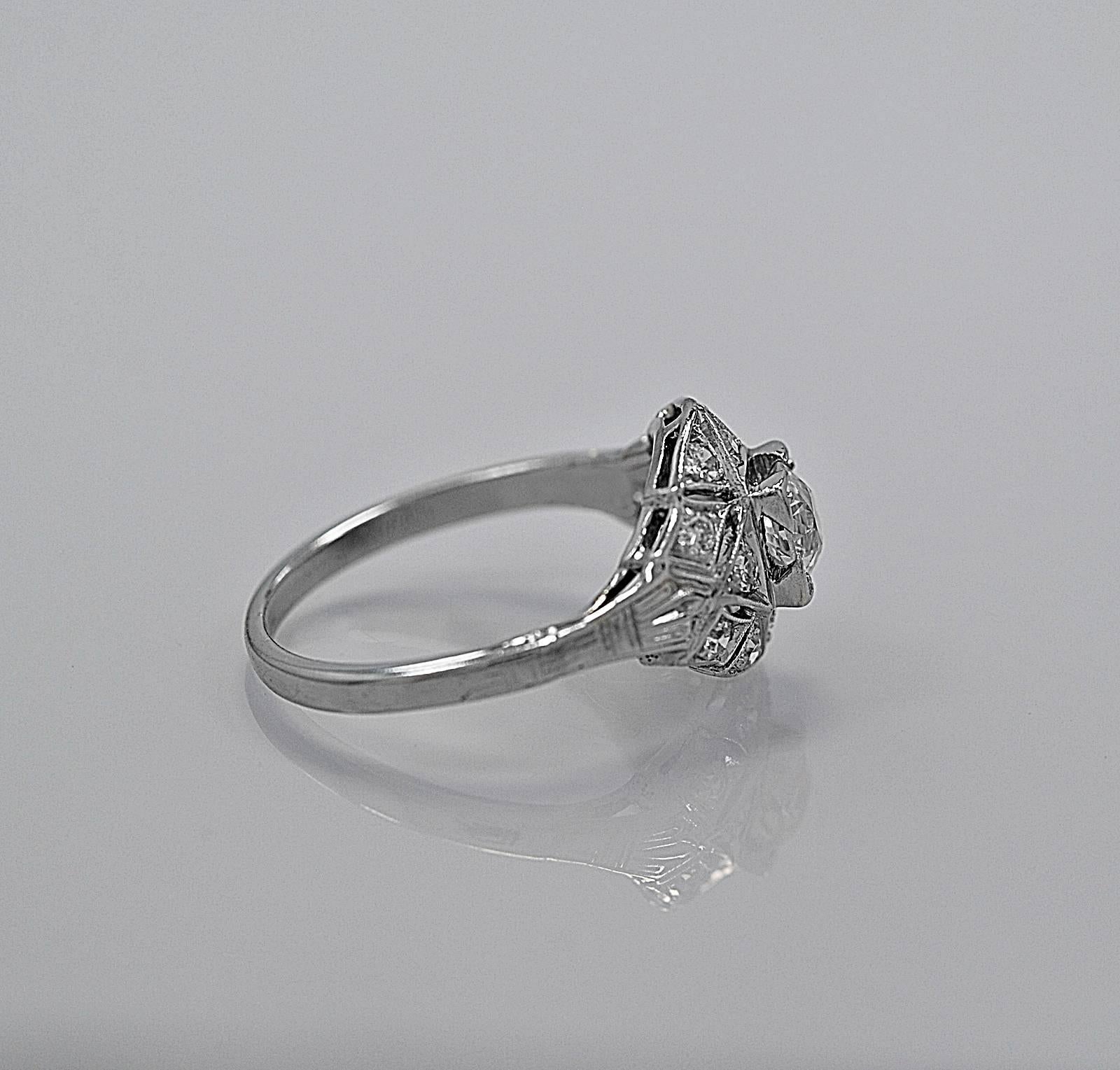 This painstakingly intricate Art Deco diamond engagement ring crafted in platinum which is known for its durability and enduring beauty. This ring features a .40ct. apx. European cut diamond with VS1 clarity and L-M color. The shimmering single cut