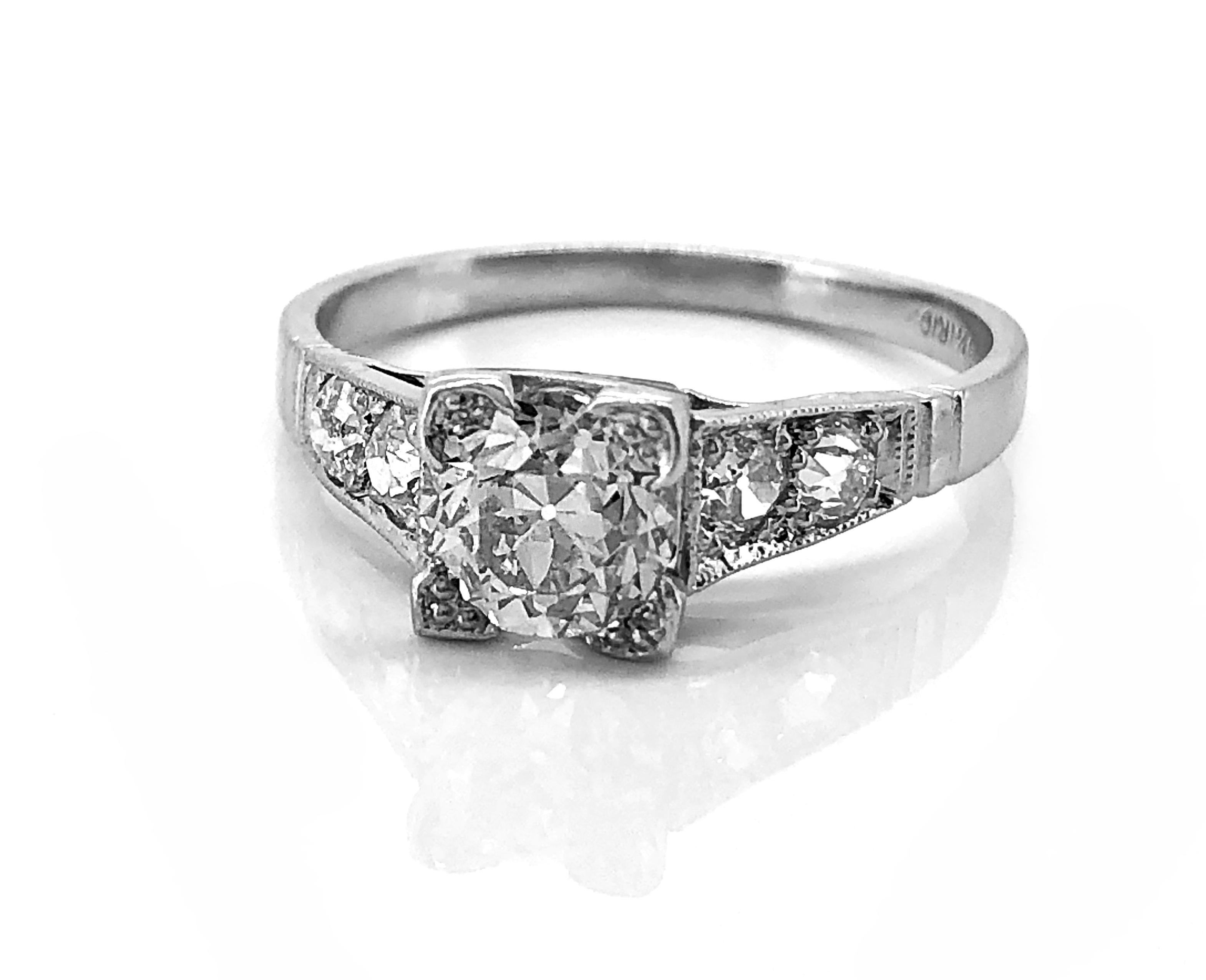A very feminine Art Deco platinum and diamond Antique engagement ring featuring a 1.22ct. apx. European cut center diamond with VS1 clarity and J color. The accenting side diamonds are .40ct. apx. T.W. and are also of wonderful quality. This ring is