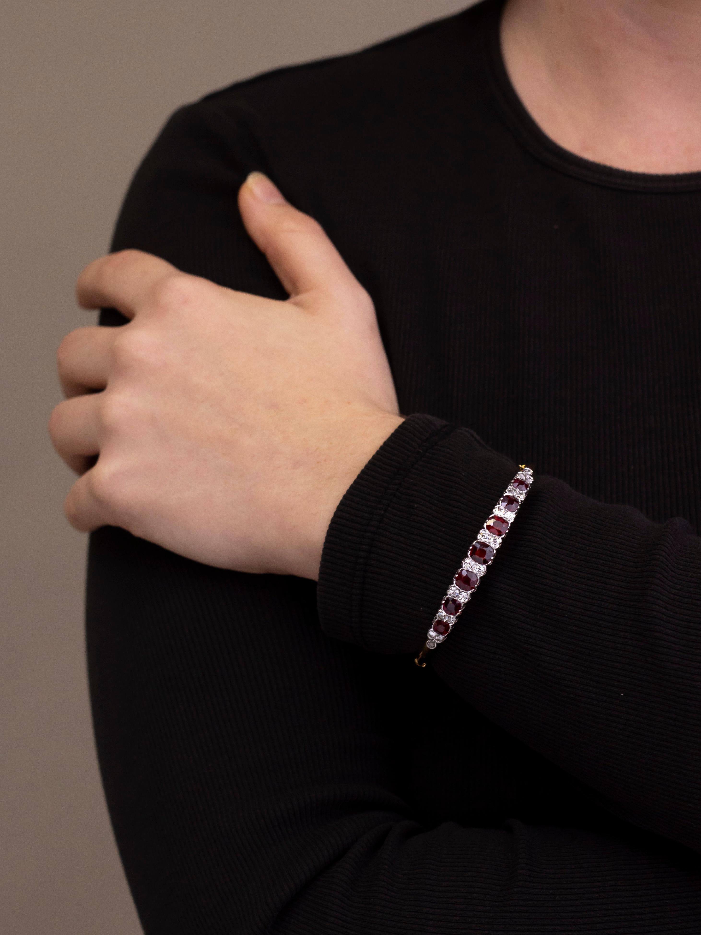 Crafted from 18 karat gold and platinum, this convertible bangle has been set with deep red garnets and diamonds. The bangle has been crafted in Sweden in the early part of the 20th century by CG Hallberg, a notable maker and jeweller to the Swedish