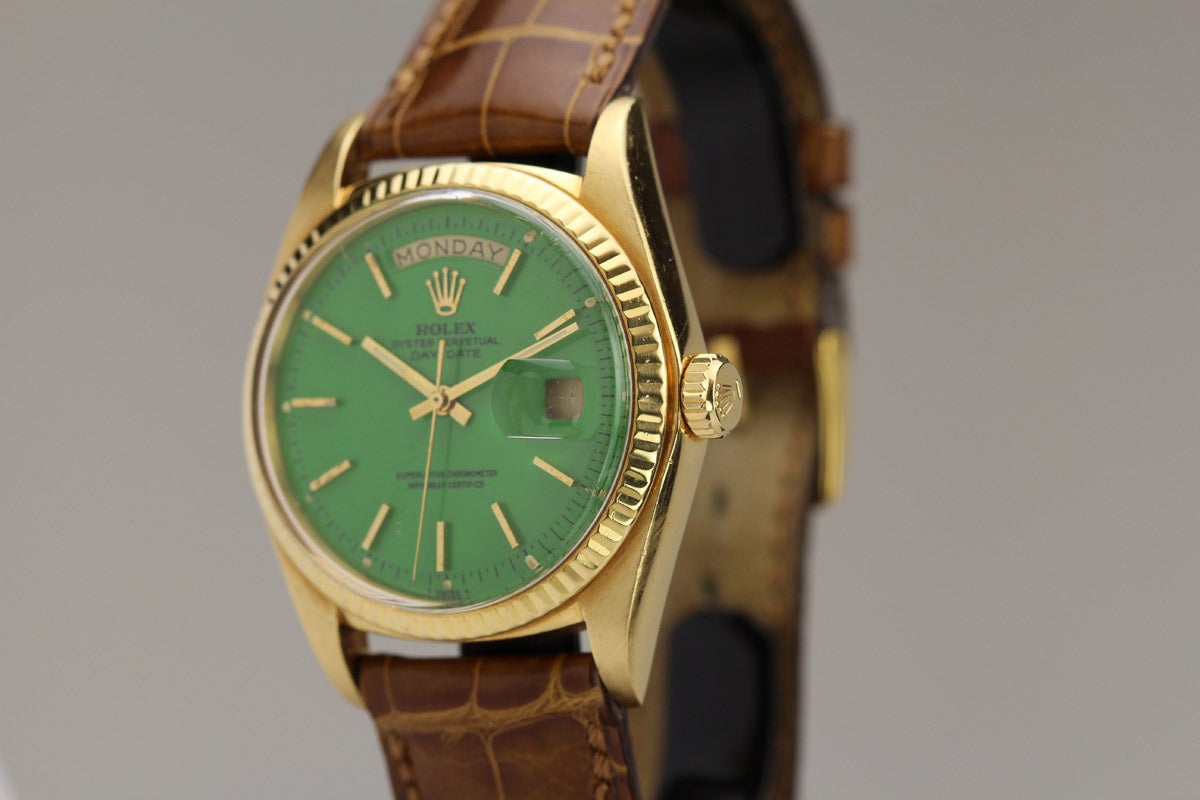 This is a Rolex 18k yellow gold Day-Date President wristwatch, Ref. 1803, with an original green Stella dial, with a fluted bezel. Stella dials are extremely rare and desirable because Rolex did not produce many of them.