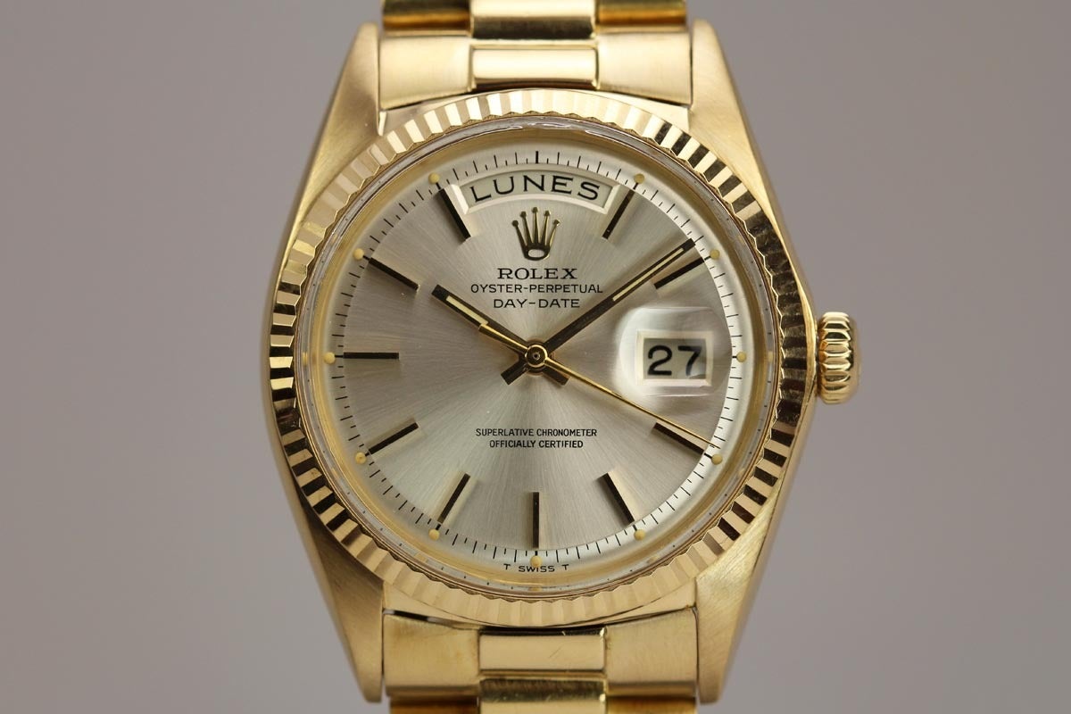 This is a beautiful, super clean 18k yellow gold Rolex Oyster Perpetual Day-Date President wristwatch from 1960. The original silvered dial is pristine with applied yellow gold baton markers. The watch has a fluted bezel and comes on an 18k yellow
