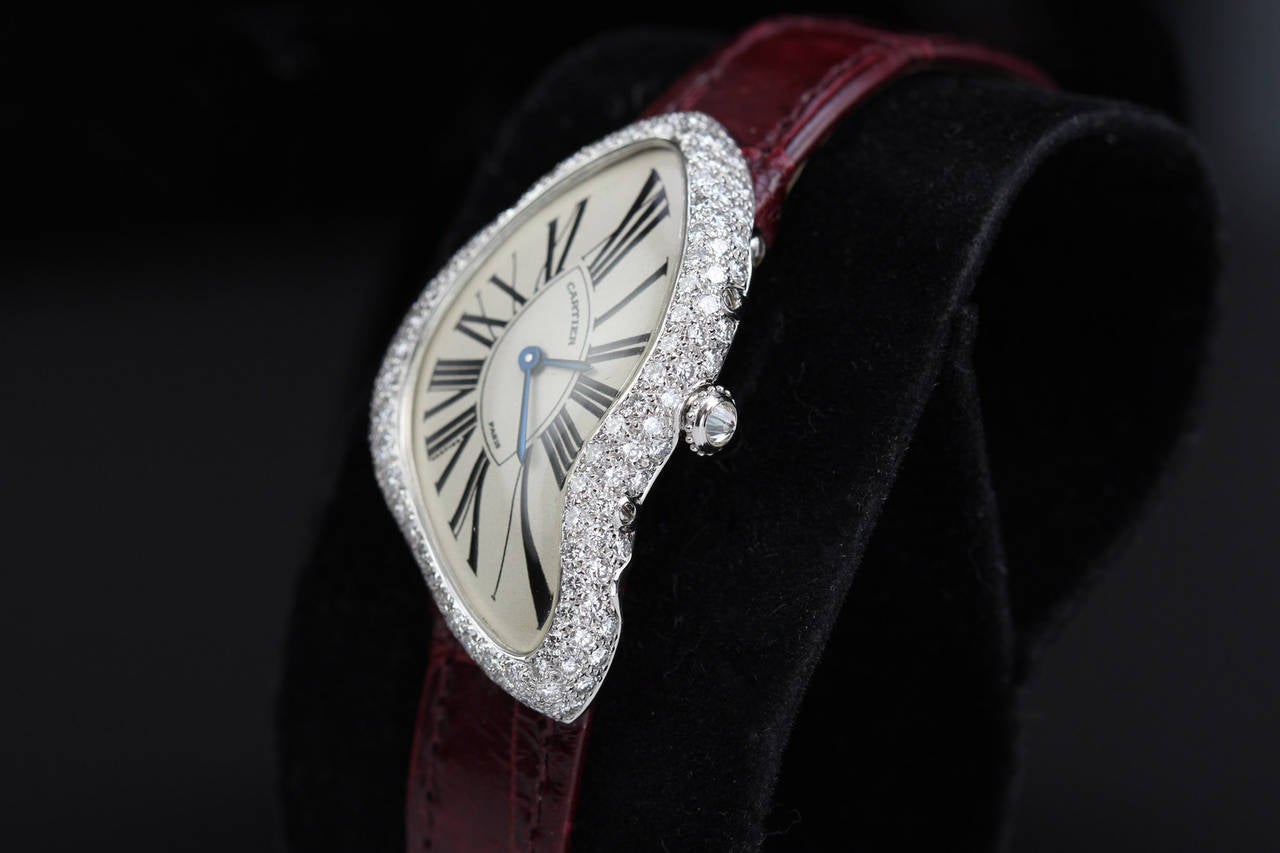This is an extremely rare version of the Cartier Crash from 2000, signed Cartier, Paris. What makes it so rare are the diamonds. Typically the Crash models from this period did not have diamonds but this particular version does. This is a real