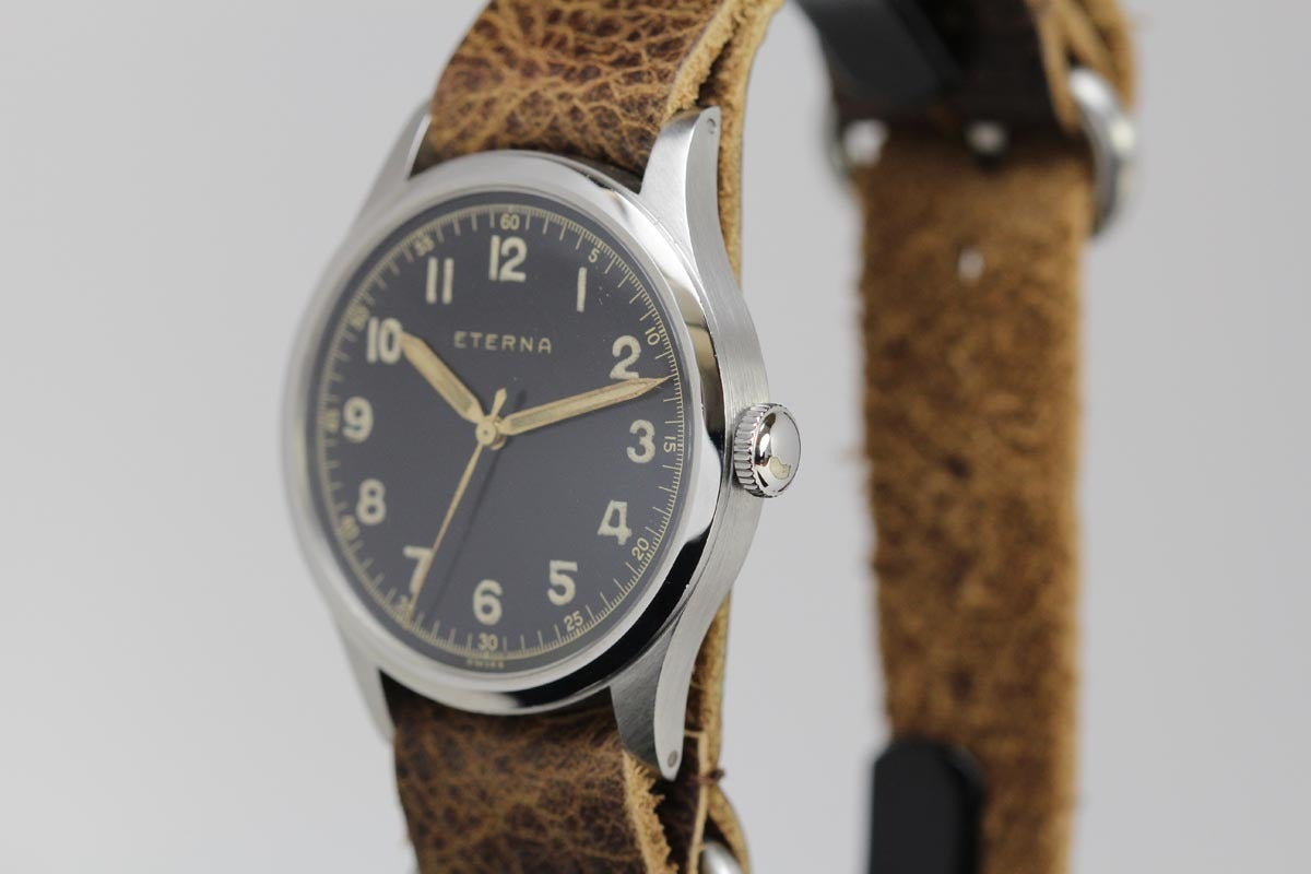 This is an Eterna military style watch in absolutely mint condition with an original black dial from the 1950s.