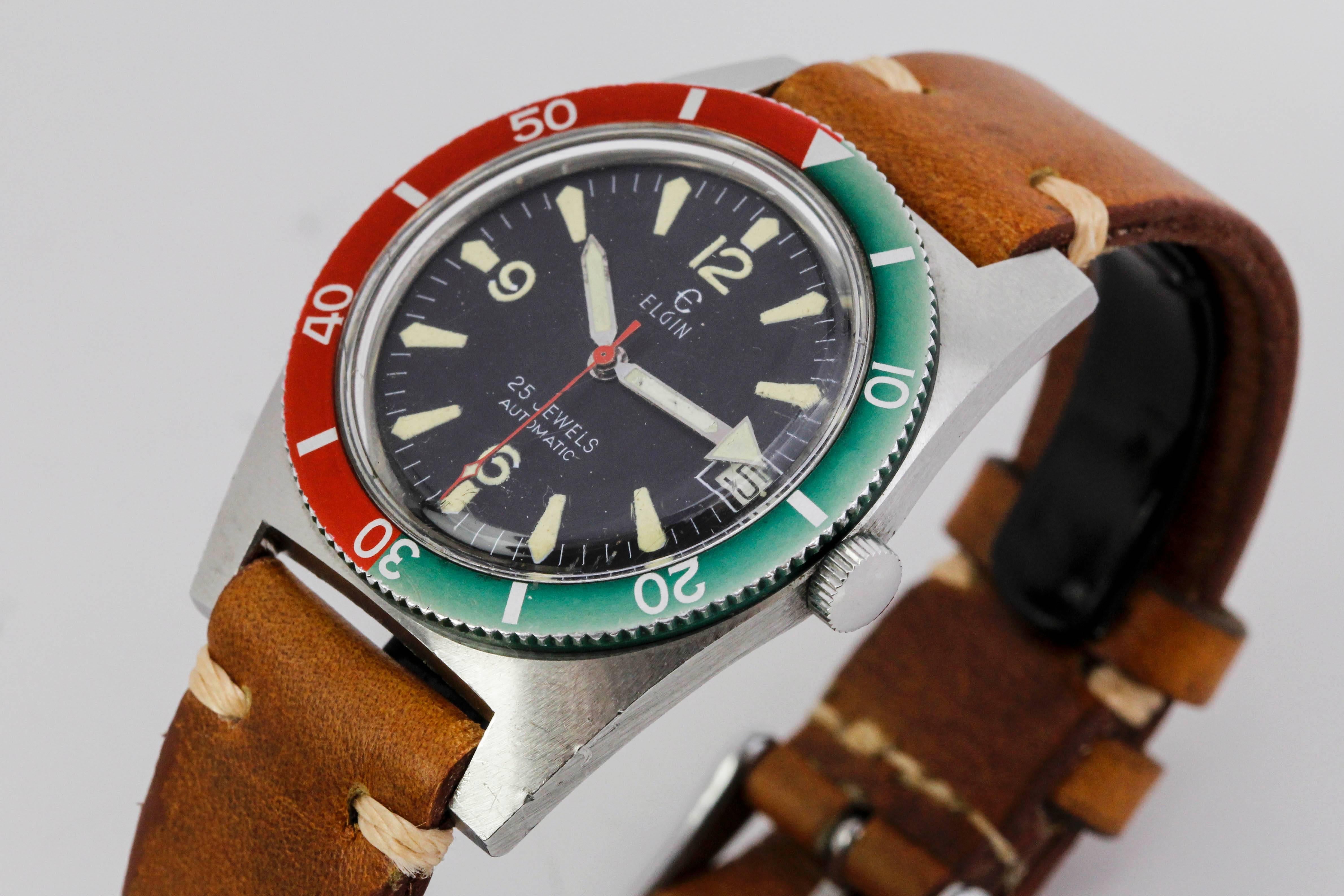 Elgin diver's watch from the 1960's with a red/blue bezel, tonneau shaped case, black dial with nicely aged markers and hands.

Bezel measures 36.28mm