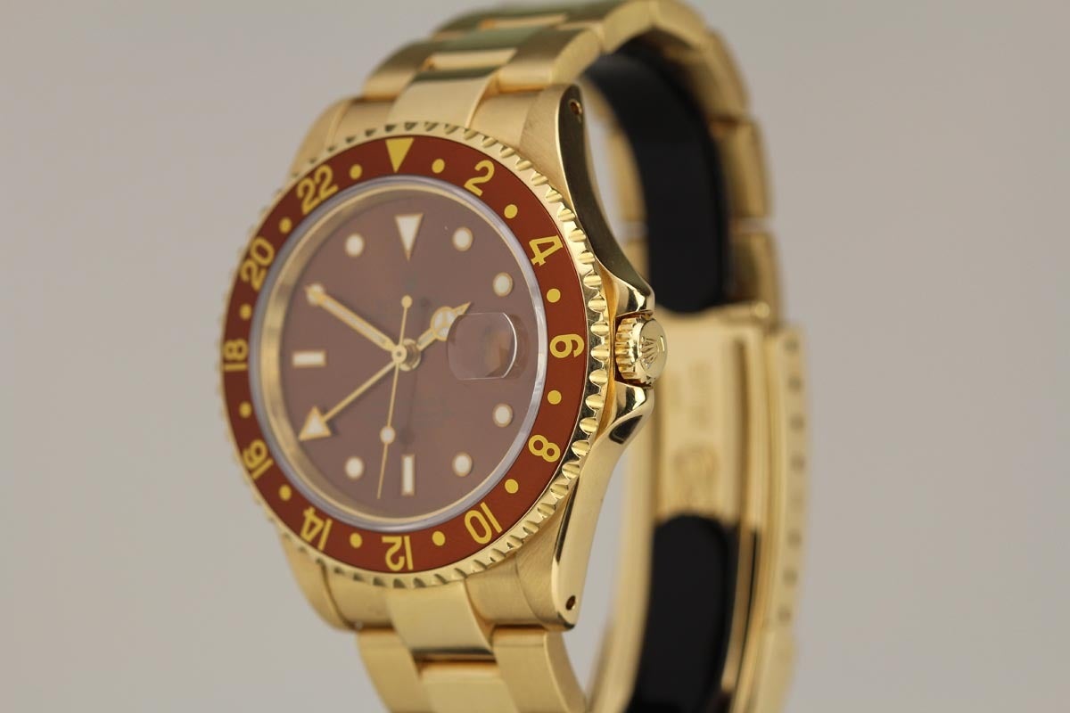 Rolex yellow gold GMT-Master II reference 16718 with a copper gilt dial, copper and yellow bi-directional rotating 24-hour bezel, sapphire crystal, 24-hour hand, and the yellow gold case is on an 18k YG Rolex oyster bracelet with a folding flip lock
