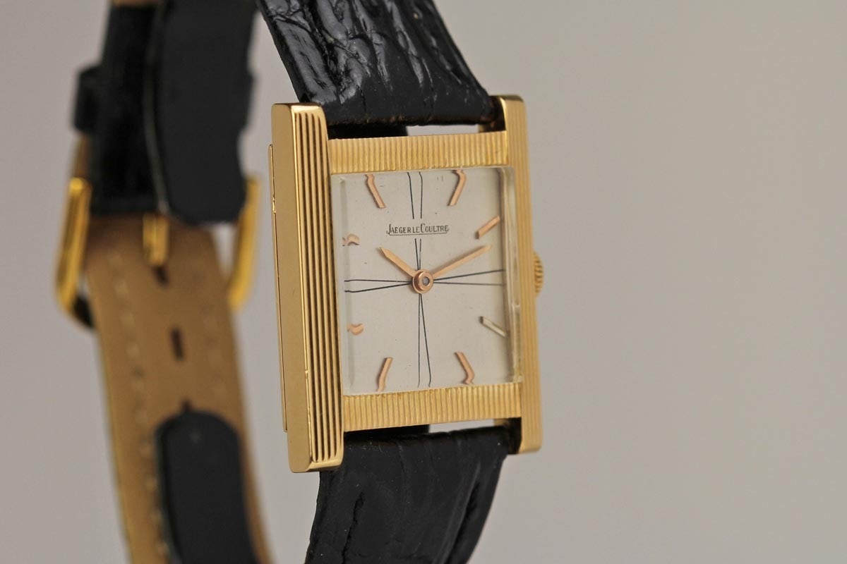Jaeger LeCoultre in 18k yellow gold with a silvered quadrant dial, báton hands, tank style textured case, and is run with a Jaeger-LeCoultre manual wind movement.