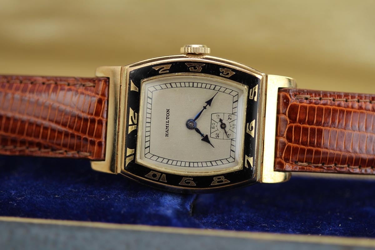This is a mint example of the 14k Hamilton Coronado from the 1930s.  This is a highly collectible and iconic model that comes with the original Hamilton box.  Typically these models are in rough shape with dirty dials and broken enamel bezels.  This