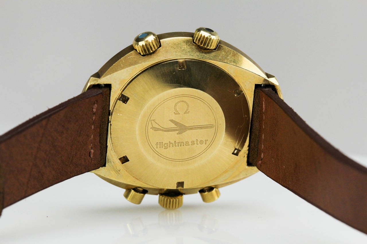 This is a 18k yellow gold version of the Omega Flightmaster, with three register chronograph, dual time zone, caliber 910 movement, and it is on a modern leather strap.

 The gold versions of these watches are extremely rare and very hard to come