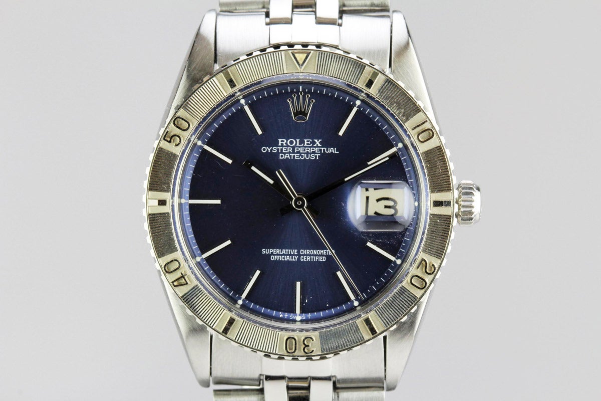 This is a beautiful Stainless Steel Rolex Datejust with White Gold Turnograph bezel on an original Rolex jubilee bracelet. This watch has an original blue dial with white writing and slash markers. This watch dates to 1966.