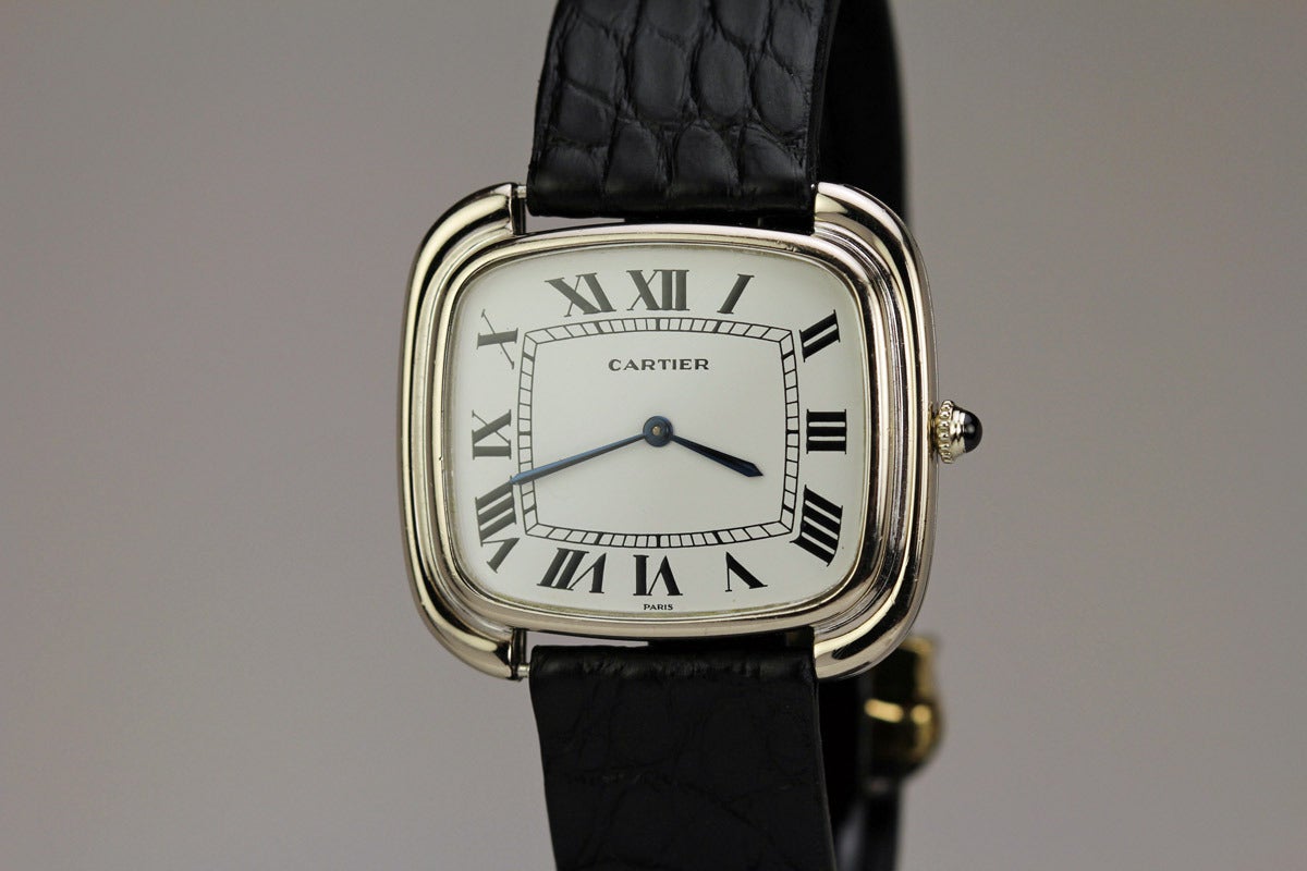 This is the Cartier TV screen watch from the 1970's in 18k white gold. The white gold version is extremely rare as 99 percent of these watches are in yellow gold. The watch is in mint condition and comes with the original Cartier deployant clasp.