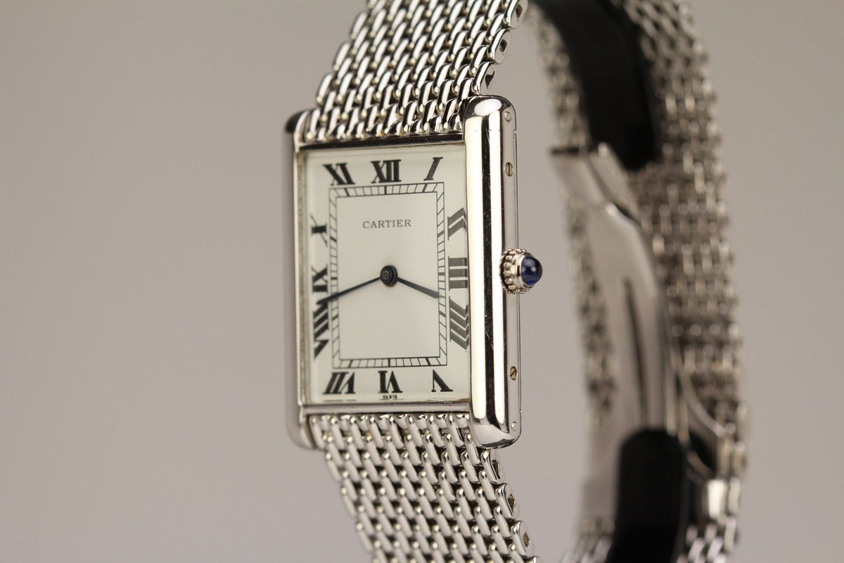 This is an extremely rare Jumbo Cartier tank from the 1970's. Typically this watch comes in yellow gold and to find one in white gold is very difficult. The watch comes on an amazing Cartier white gold rice style bracelet which is also extremely