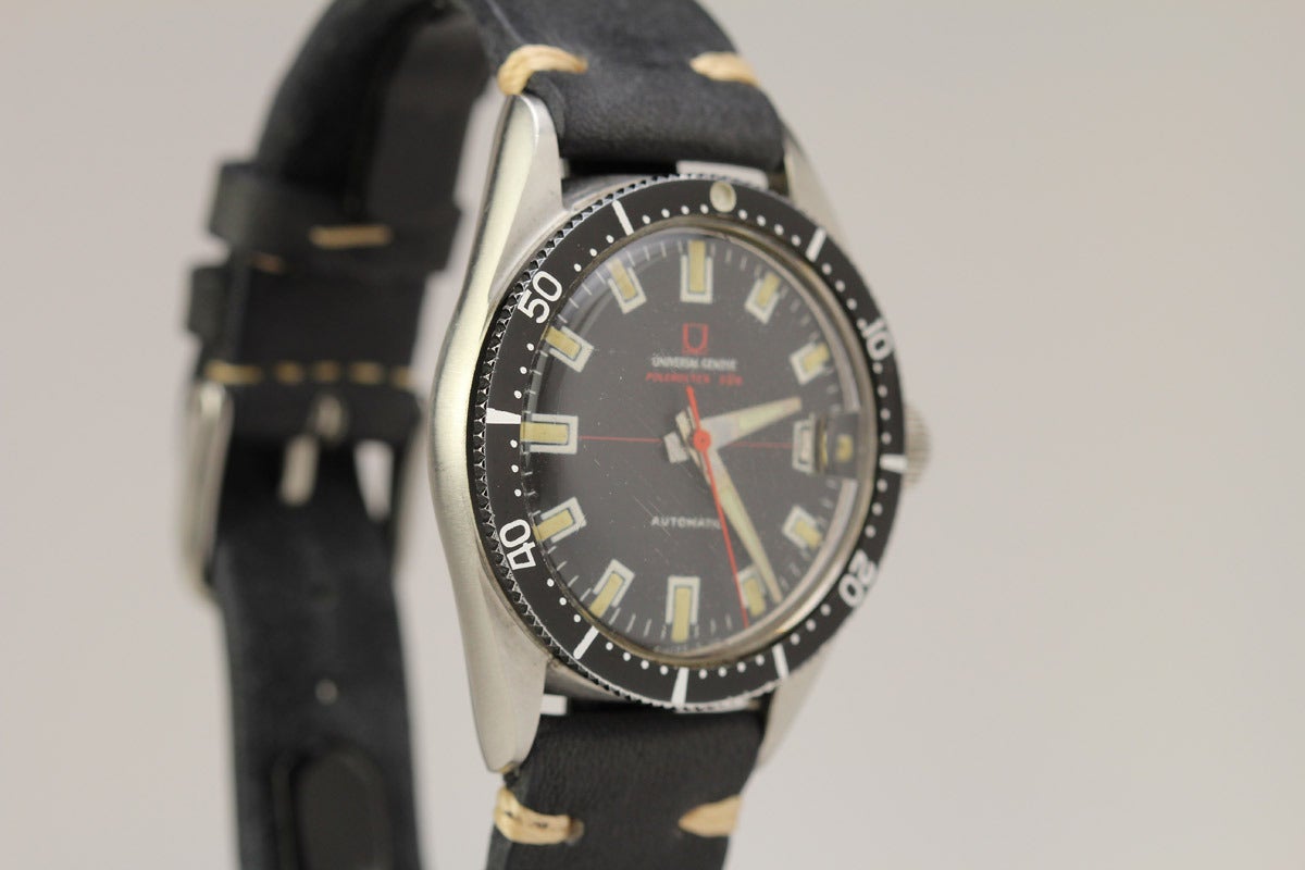 This is a rare stainless steel Universal Geneve Polerouter Sub automatic wristwatch, circa 1960's, with an asymmetric case, screw back, a signed screw-down crown, black aluminum bezel, original dial, and automatic micro rotor movement.