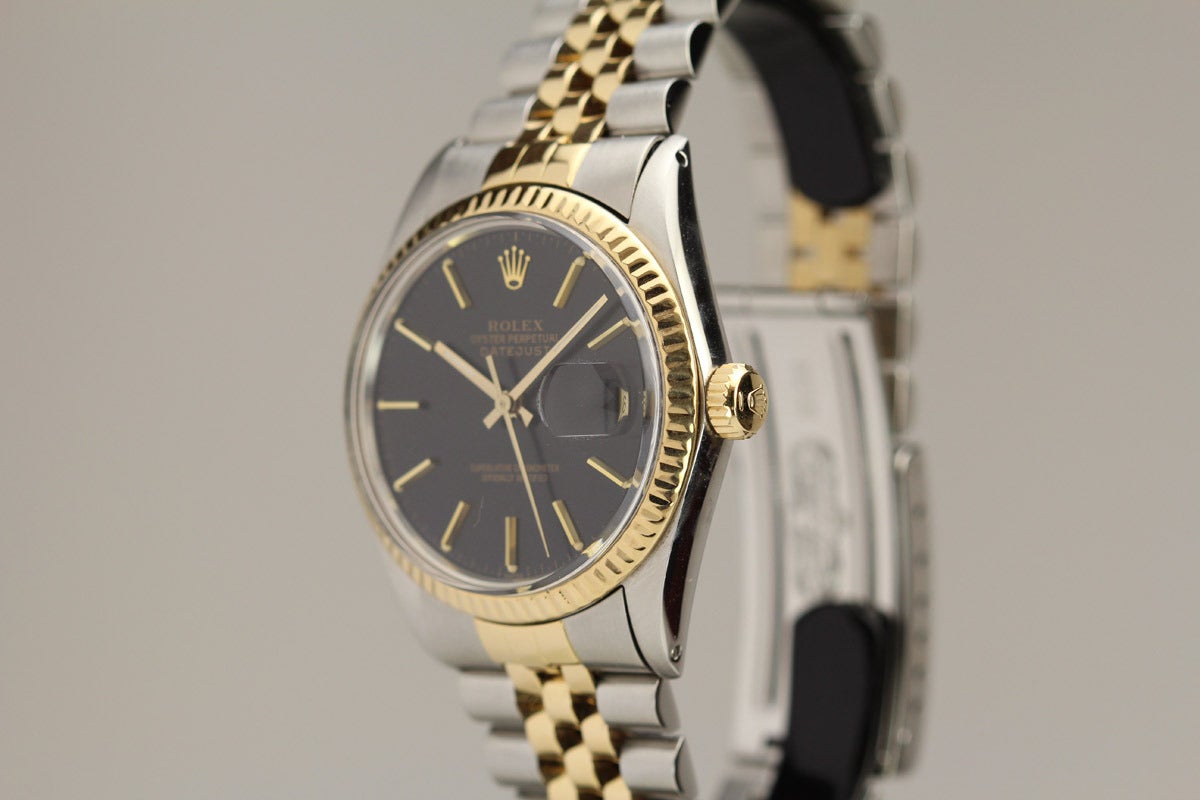 This is a Rolex Datejust reference 16013 from 1985 with an original black gilt dial, gold fluted bezel, on a Rolex Stainless Steel and Gold jubilee bracelet.