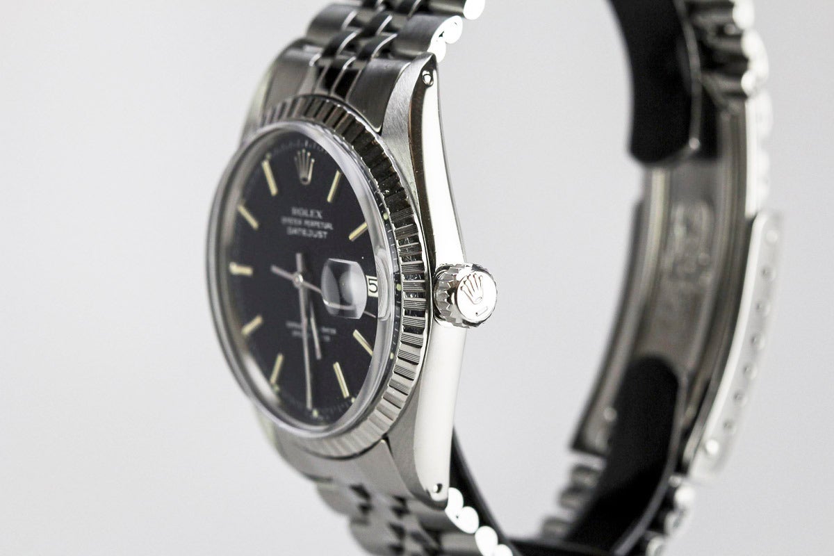 This is an all original black dial Rolex Datejust manufactured in 1972 and then originally sold in 1974. This watch has a stainless steel fluted bezel, acrylic crystal and comes on a Rolex stainless steel jubilee bracelet. This watch comes with its