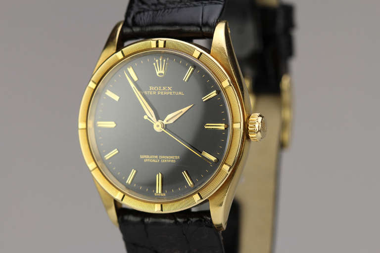 Rolex 18k yellow gold Chronometer wristwatch, Ref. 1007, circa 1960s, with original black gilt dial, engine-turned bezel, automatic movement. Comes with original papers and chrono certificate.