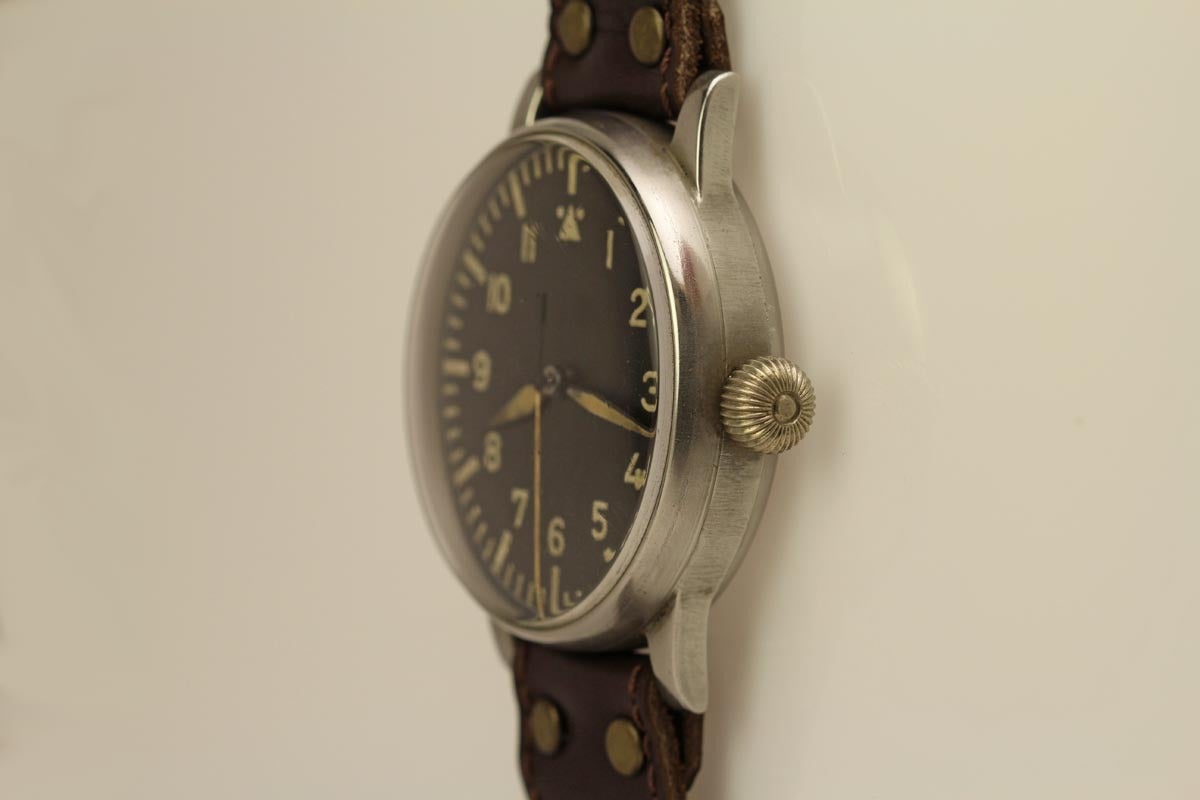 This is a great example of a WWII Pilots watch made by A. Lange & Söhne. It is made of a special non-magnetic alloy of nickel silver. The extra big case is fitted with a wide band which allowed the watch to be worn over the flight suit. In