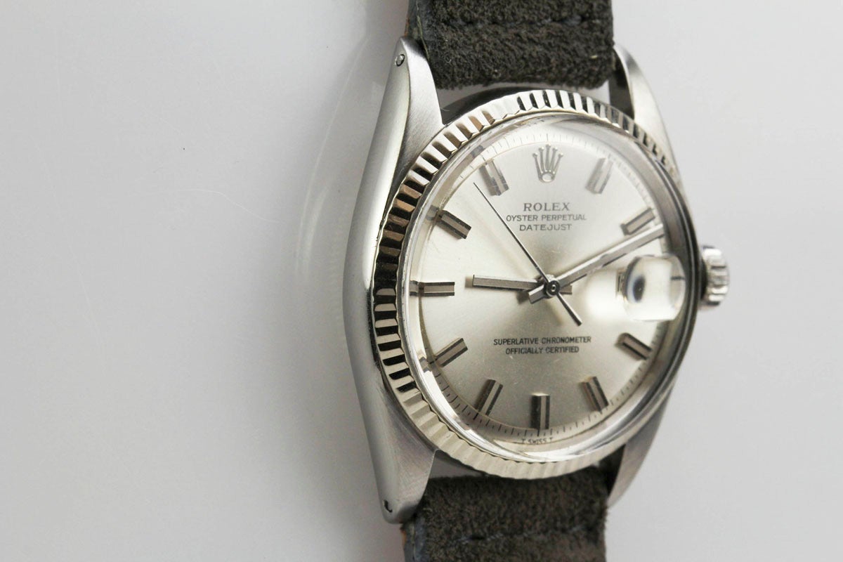 This is a great Rolex Stainless Steel Datejust with white gold fluted bezel from 1964. The silver dial is super clean and the 