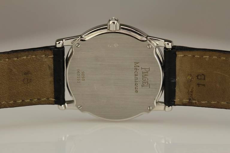 Piaget 18k white gold and diamond wristwatch, Ref. 9895, with a tuxedo style textured dial, a manual-wind movement on Piaget leather strap on white gold tang buckle.