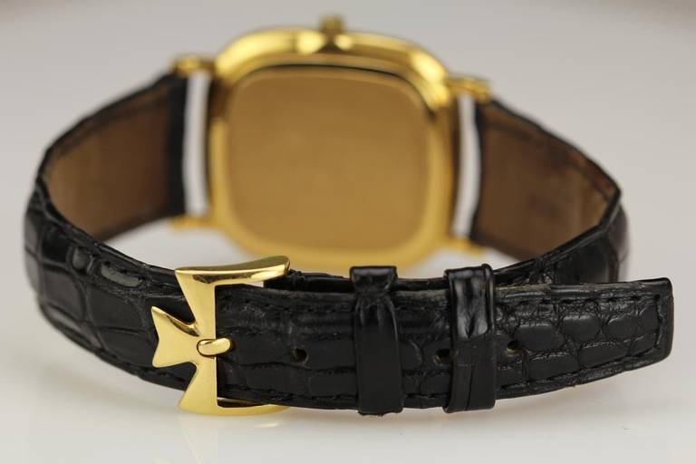 Vacheron Constantin 18k yellow gold cushion wristwatch, Ref. 33595, with diamond bezel, has a manual-wind movement. On a Vacheron Constantin leather strap and a VC yellow gold tang buckle.