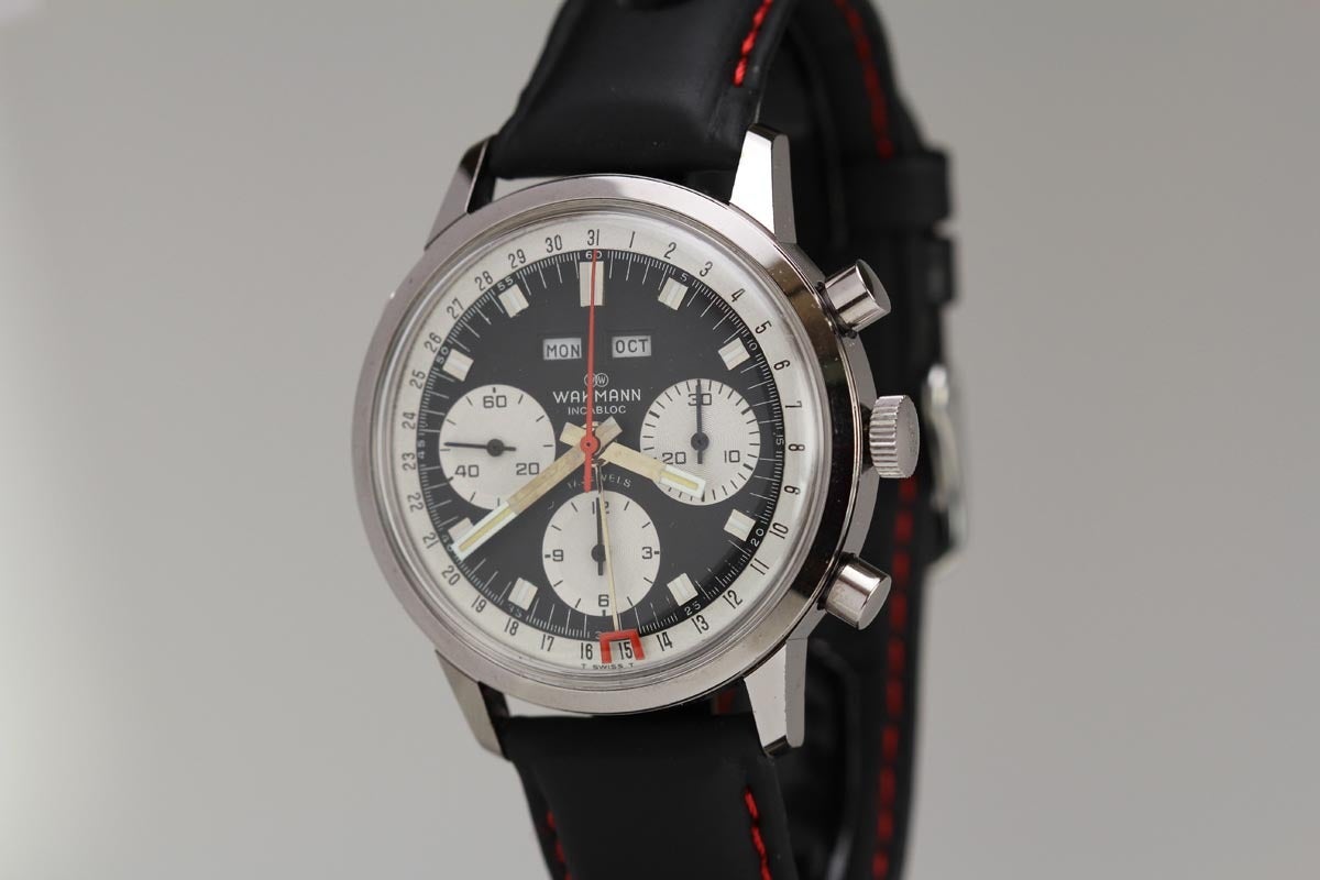 Wakmann Gigandet stainless steel chronograph wristwatch, manual-wind movement, 17-jewels, black dial, white date tracks, white registers, red chronograph hand, red-tipped date hand.