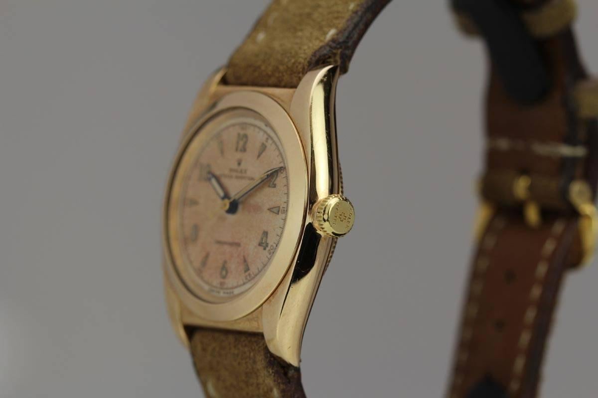 This is a beauty from the 1940's. This solid 14kt yellow gold Rolex Bubbleback from 1946 is in excellent condition. The case is nice and sharp and in pristine condition. The original dial has a beautiful pink tone patinaed dial. This watch is a