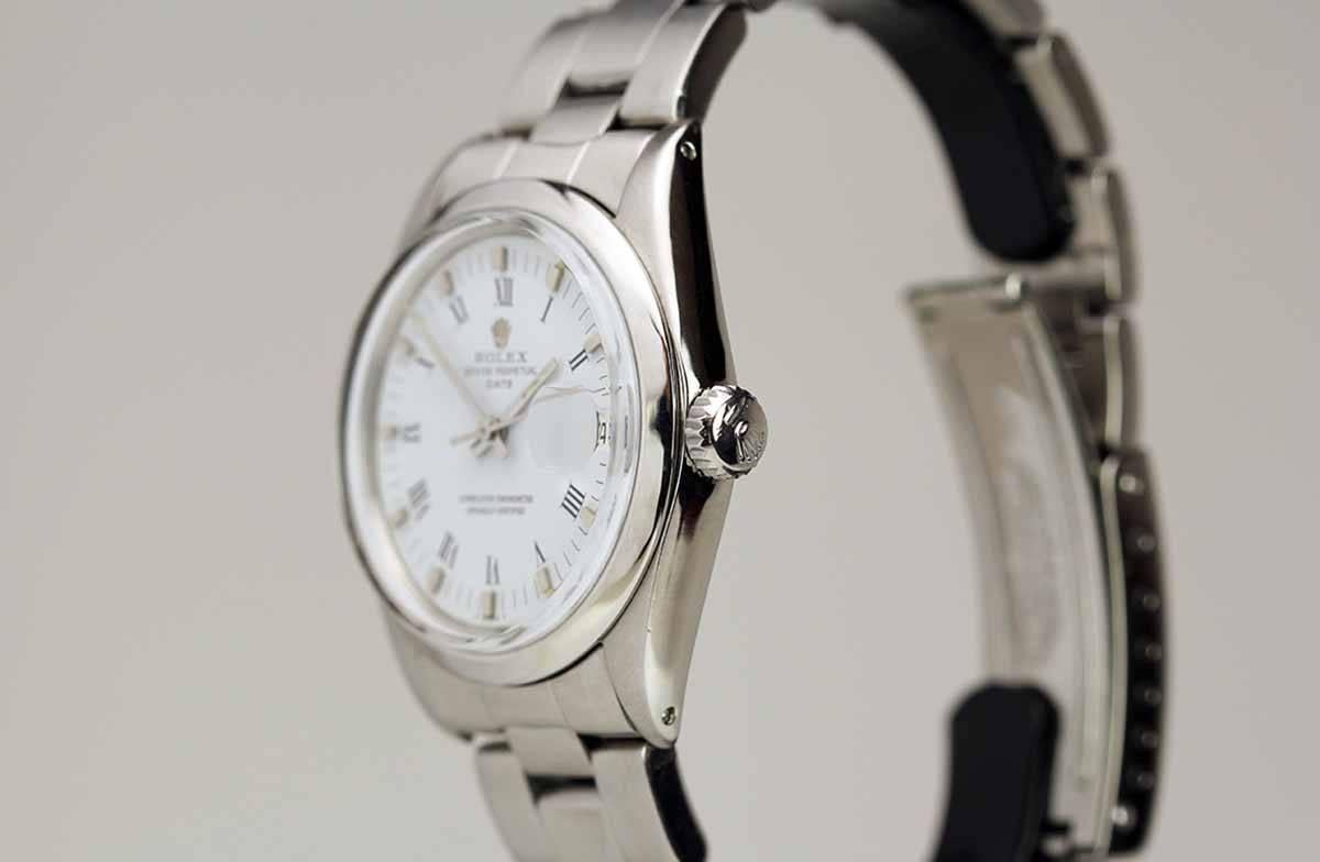 Rolex Date reference 1500 with white dial, date aperture, plastic crystal, automatic movement, on a Rolex oyster bracelet.