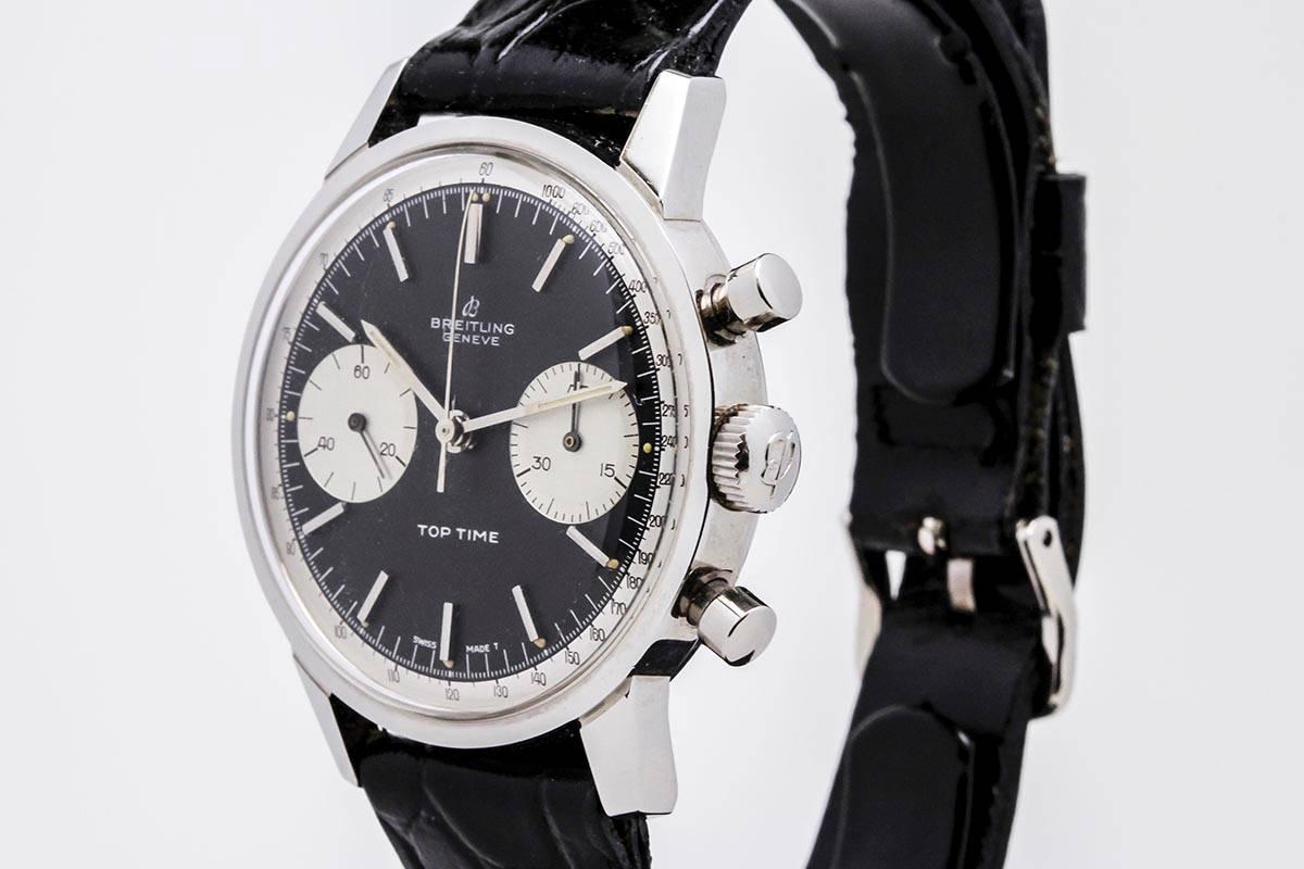 Breitling Top Time chronograph reference 2002 aka Reverse Panda in stainless steel. The case is in beautiful condition with a some surface scratches, sharp lugs, and clear writing on the back case . The dial appears to be original in excellent
