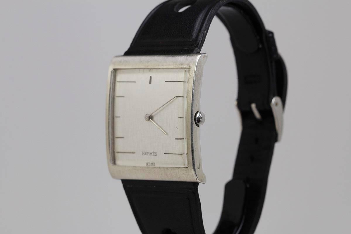 Corum for Hermes Buckingham Ref 54121 in sterling silver with hallmarks. This is run by a manual wind Corum movement. On a leather strap with a Corum buckle.