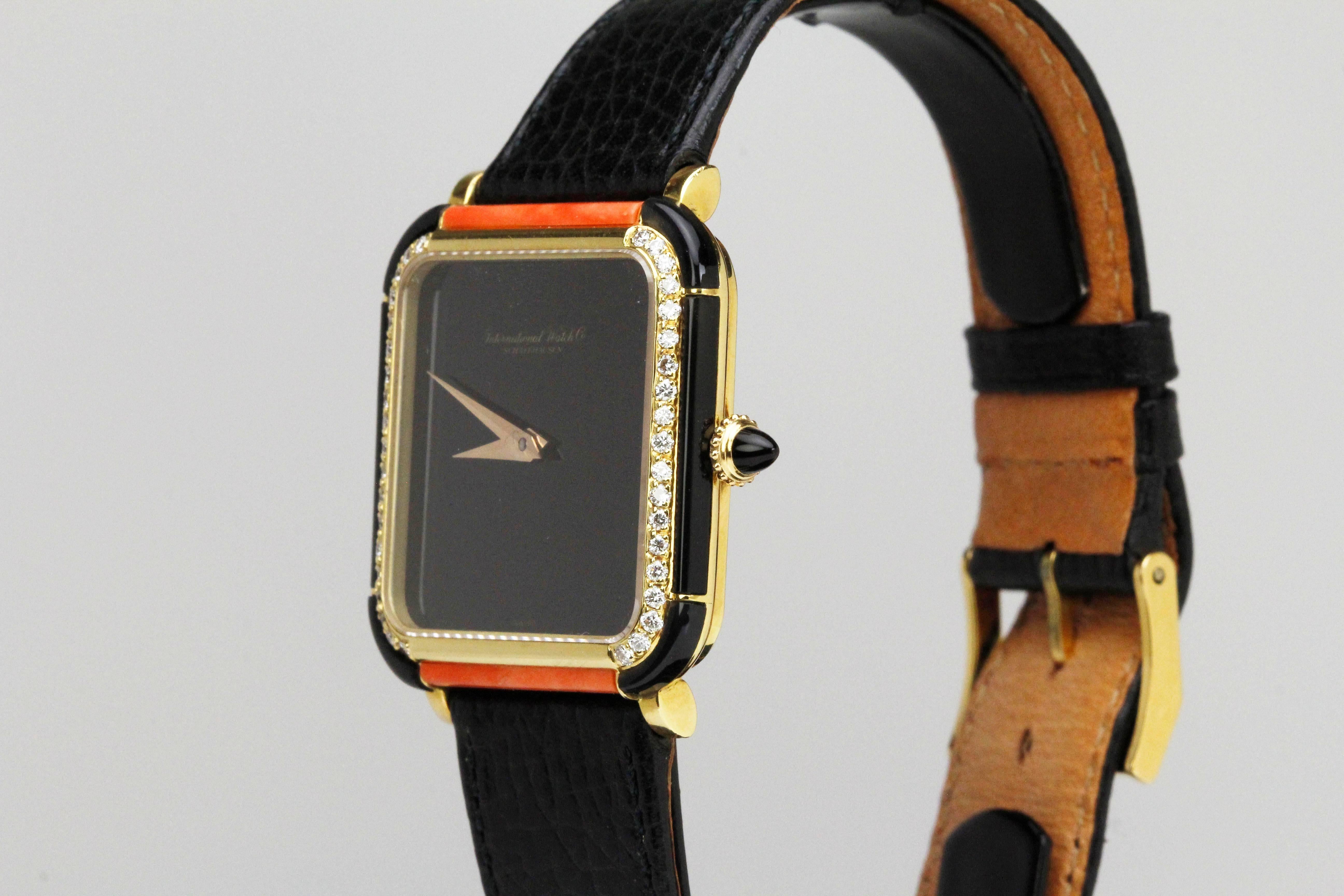 Elegant INTERNATIONAL WATCH CO. with onyx dial, onyx/coral/diamond panels, and onyx crown. This is a manual wind movement. Comes on a leather strap and gold plated IWC buckle. This can be worn by either men or women. 30mm width without crown x 35mm