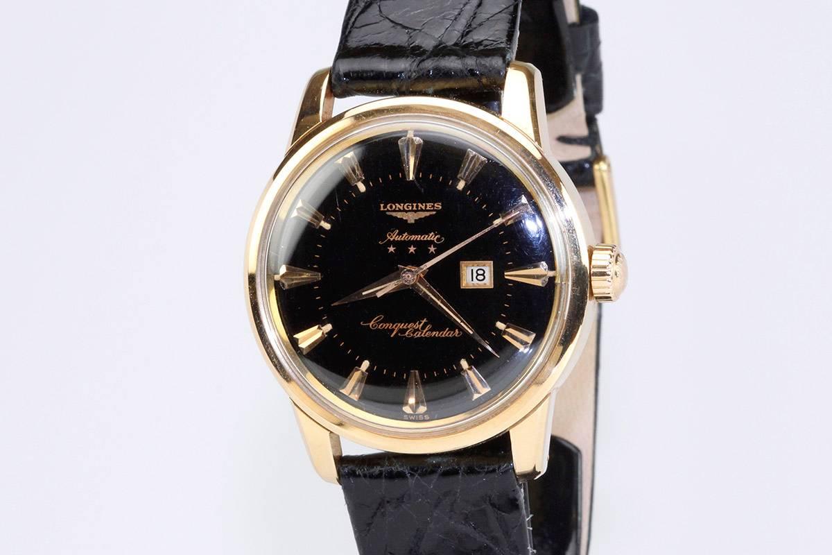 This is a very interesting 18k Rose gold Longines Conquest from the 1950s with a black original dial. Typically the gold conquest models have gold tones dials and a black dial for this model is extremely rare and quite attractive. The enamel
