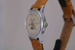 Orologio da polso automatico Enicar in acciaio inossidabile con tripla data e fasi lunari, circa anni '40