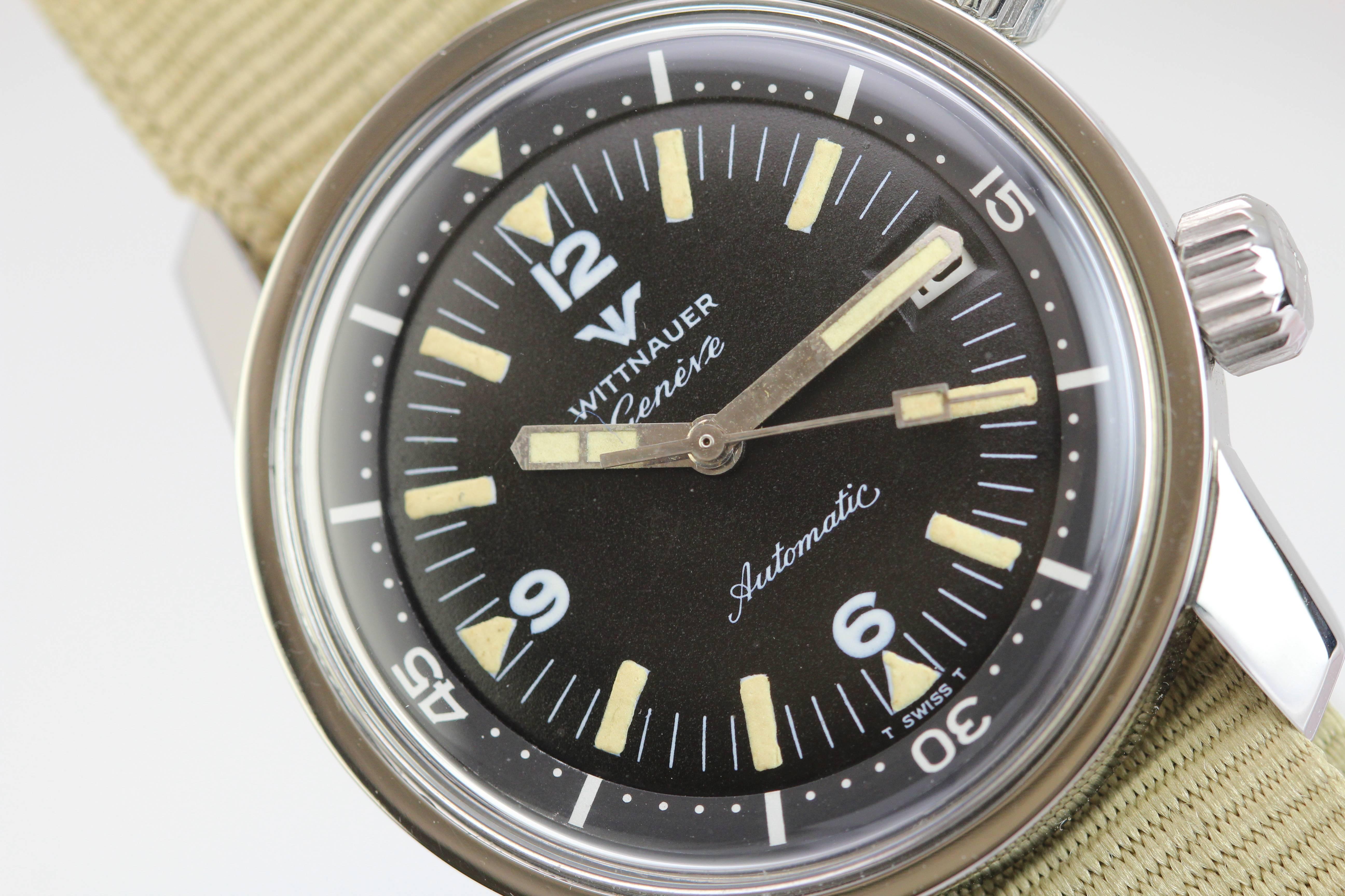 Wittnauer Geneve diver's watch with an automatic caliber 53, 17-Jewel movement.  The dial has a lovely patina, white tracking, the 36mm case features oversized dual crowns with cross-hatch markings and W logo. This watch is on a modern nylon