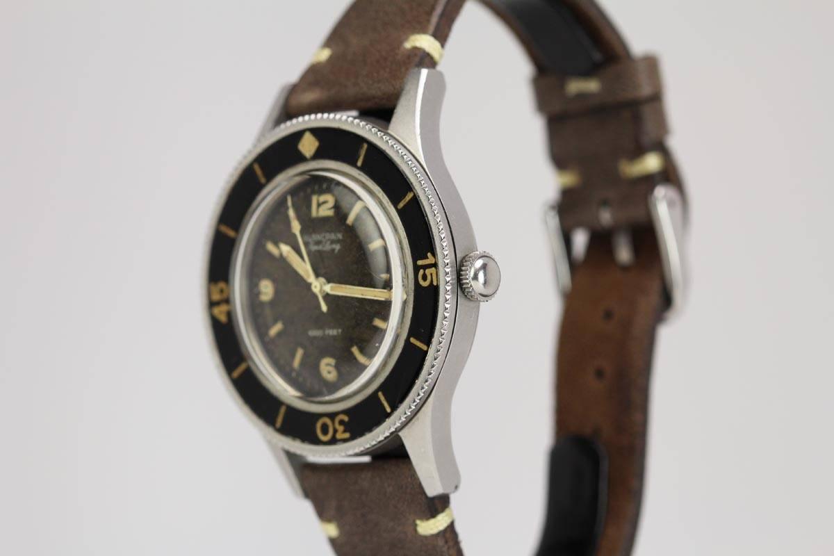 This is a great example of the vintage Blancpain Fifty Fathoms Aqualung model with a beautiful original dial and hands. The dial has turned a beautiful tropical brown color which is unusual for these models. The case is excellent with very little