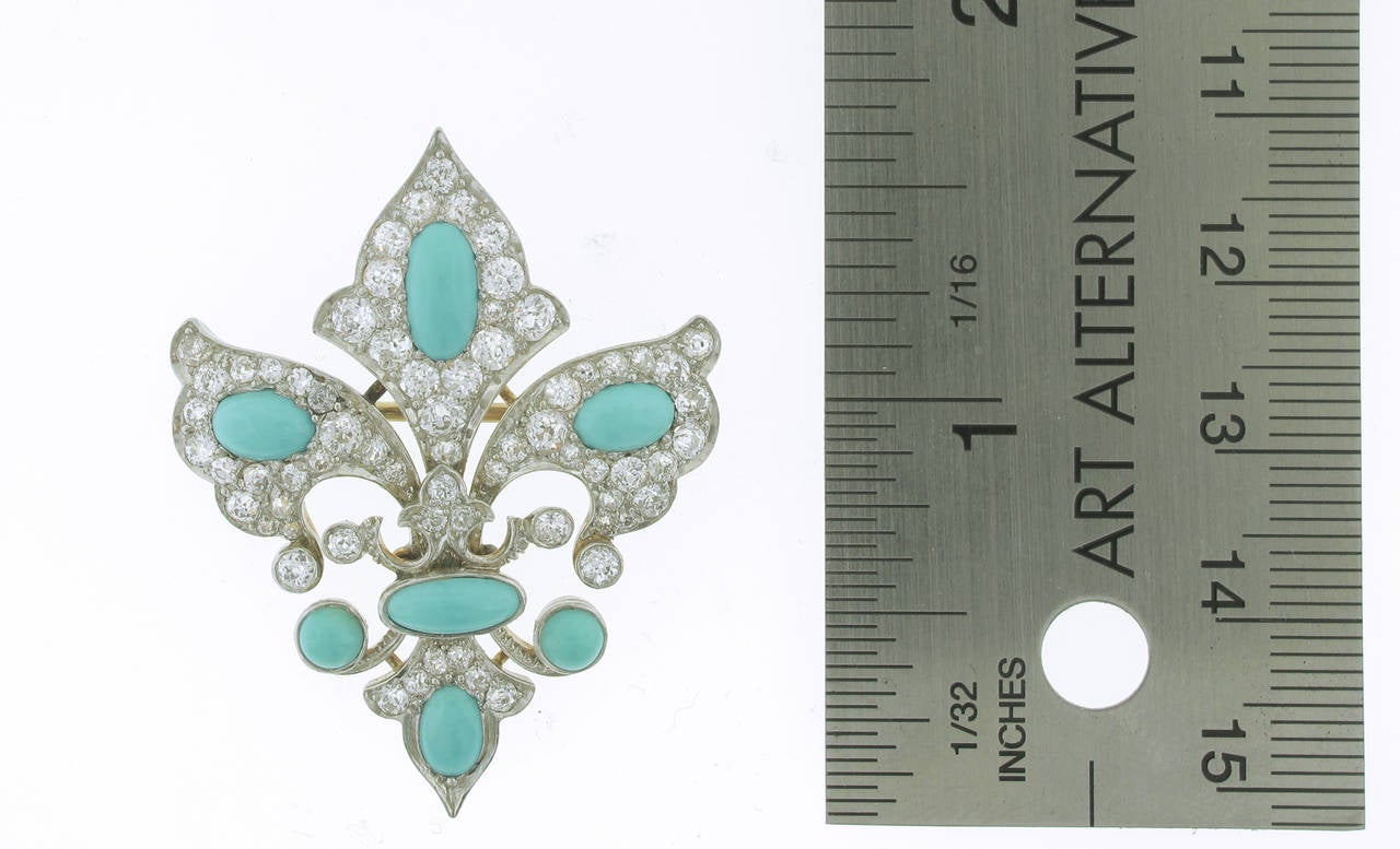 This turquoise and diamond Fleur-de-lis brooch is circa 1900. The brooch contains 81 bead set diamonds with a total weight of 2.25 carats. 7 stunning turquoise stones emerge from the diamonds. The brooch is 1.75 inches in length and 1.25 inches in