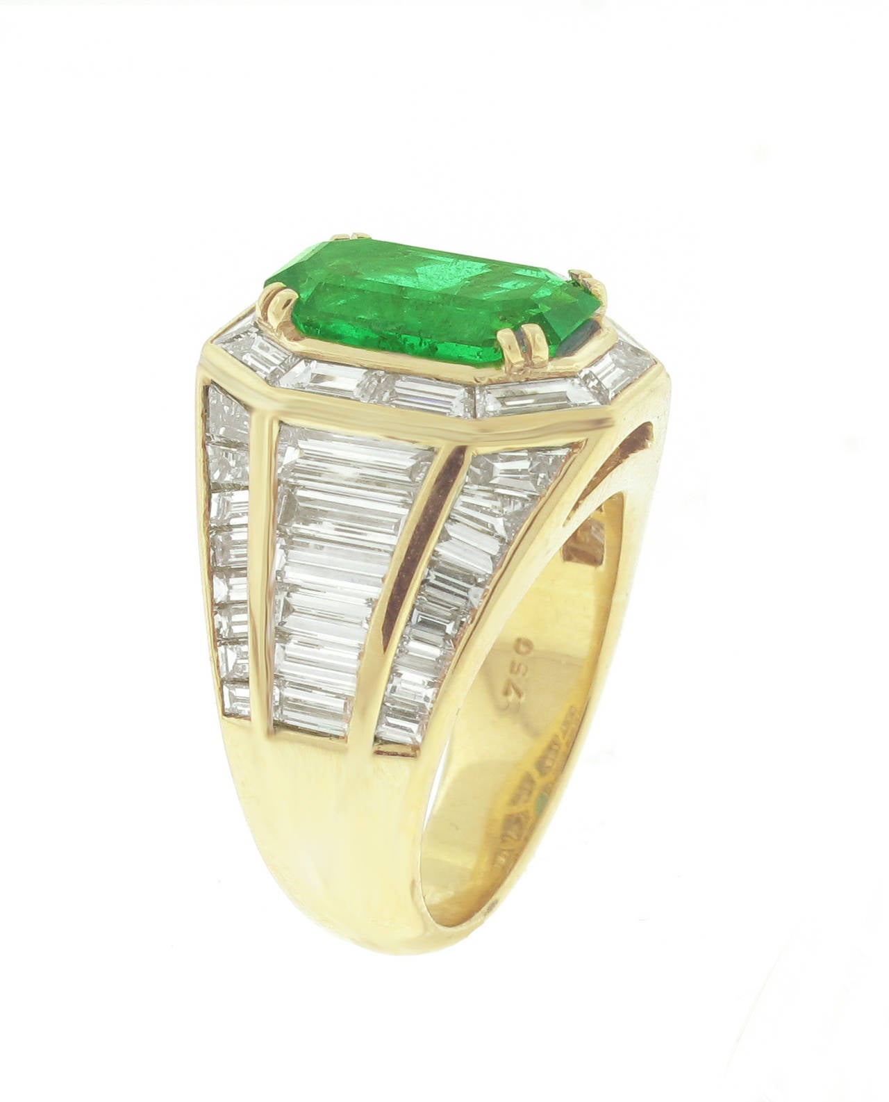 From renowned Italian master jeweler Picchiotti an emerald and diamond ring. The emerald weighs 3.28 carats. An American Gemological laboratory report states the emerald is from Colombia with minor traditional enhancements  (rare). The  44 baguette