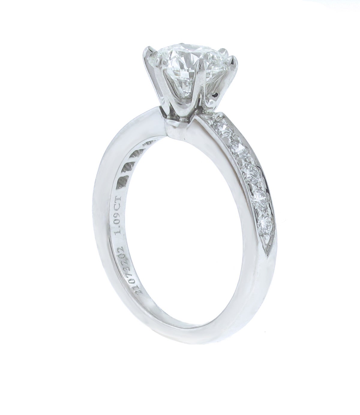 Tiffany & Co. classic diamond engagement ring. Set with a center 1.09 carat diamond. The diamond is G color, VS2 clarity and has an excellent cut grade.
The band contains  ten diamonds weighing approximately .25 carat. The ring come in the original